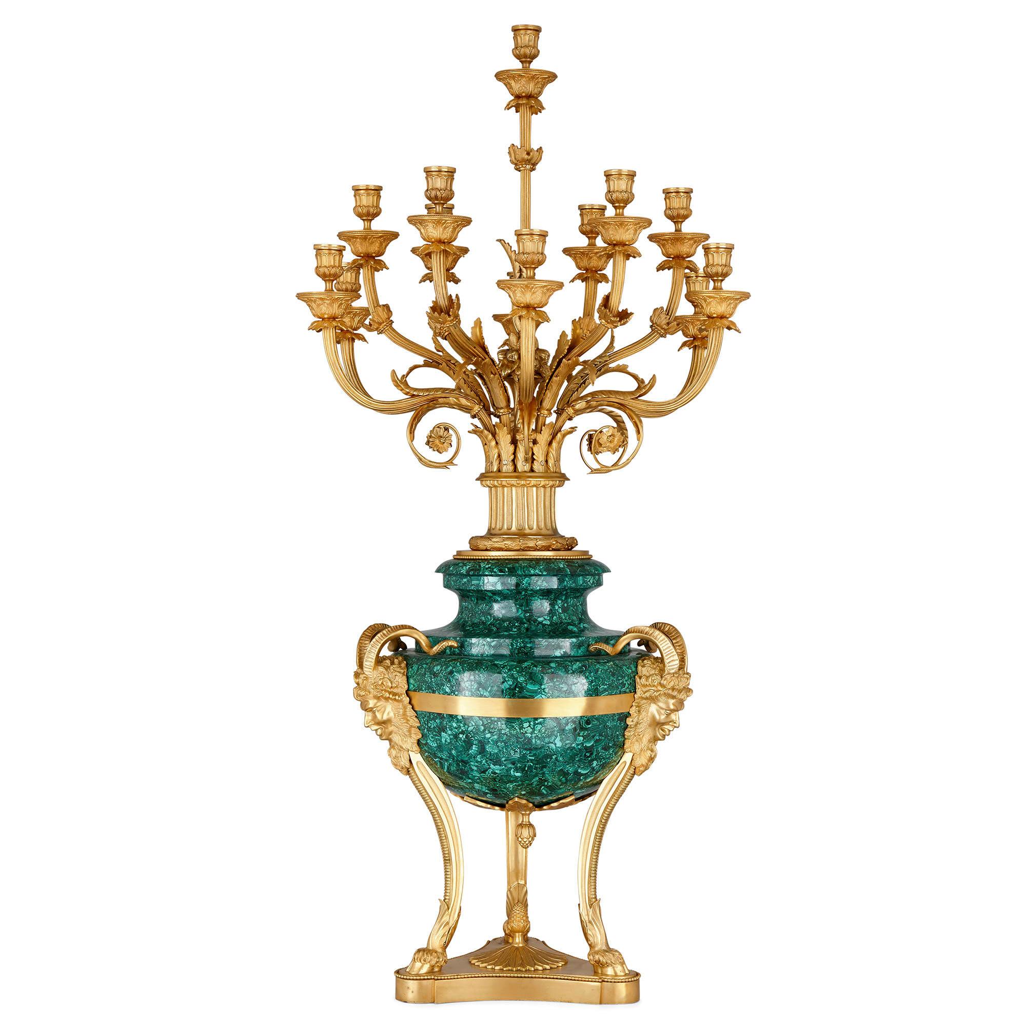 Pair of large gilt bronze and malachite neoclassical style candelabra
French, 20th century
Measures: Height 122cm, diameter 60cm

This large pair of neoclassical style candelabra is wrought from malachite and gilt bronze. Each candelabrum