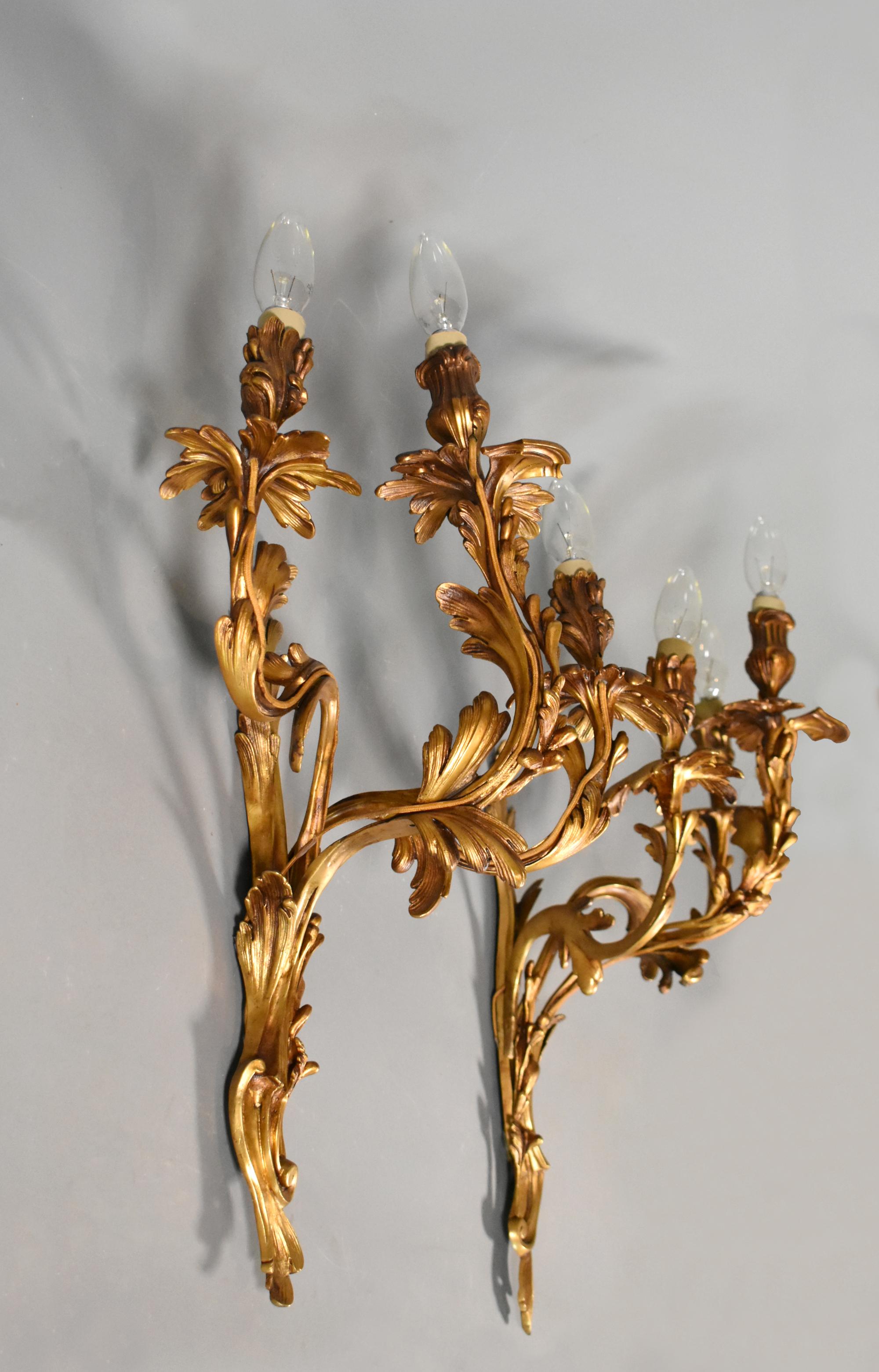 Pair of Large Gilt Bronze Wall Sconces Louis XV Style 

These large and impressive gilt bronze wall sconces each support three beautifully decorated out-swept arms stemming from the main central support. 

Both sconces have a wonderfully aged patina