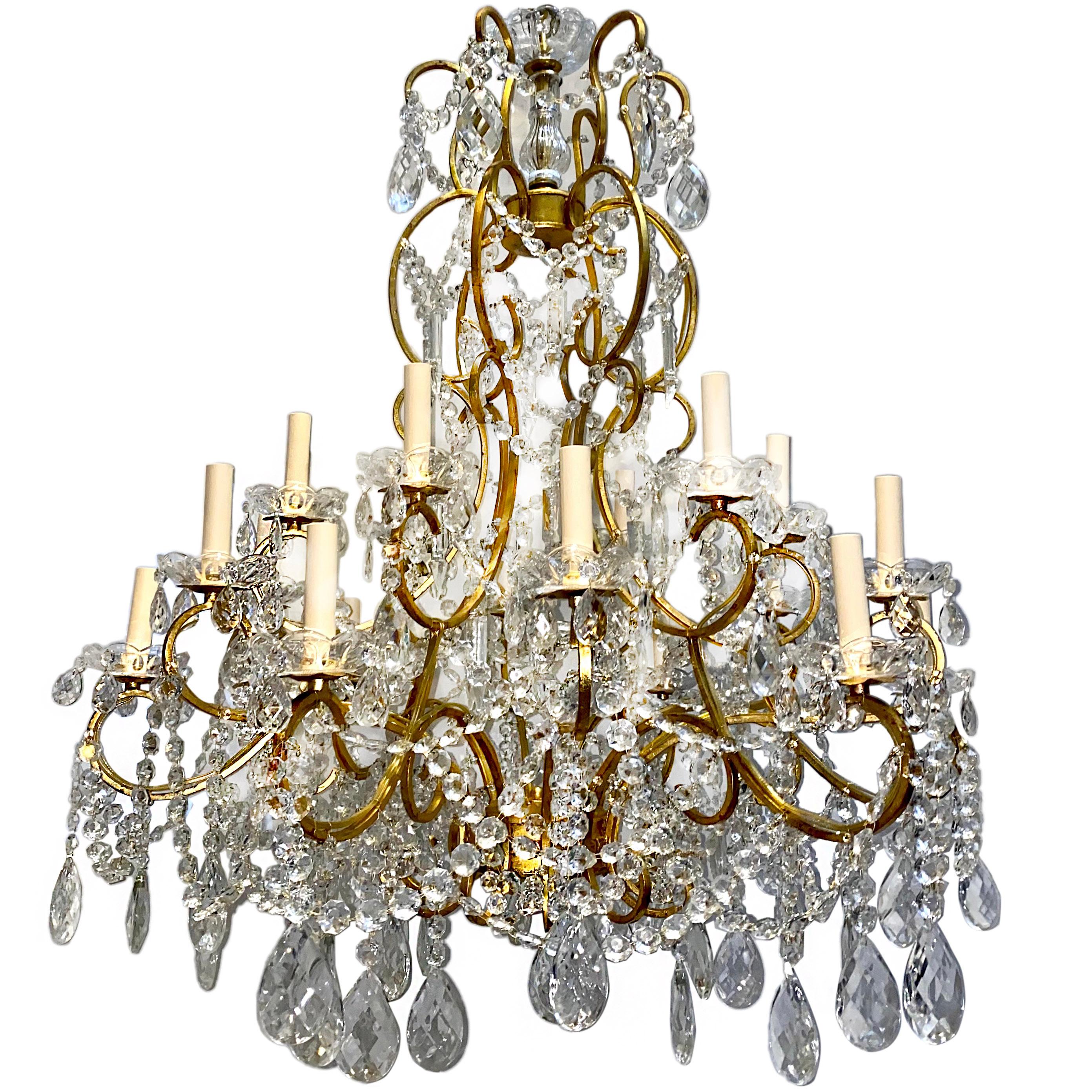 A pair of large circa 1920s Italian gilt metal and crystal eighteen-arm chandeliers with original patina. Sold individually.

Measurements:
Diameter: 34