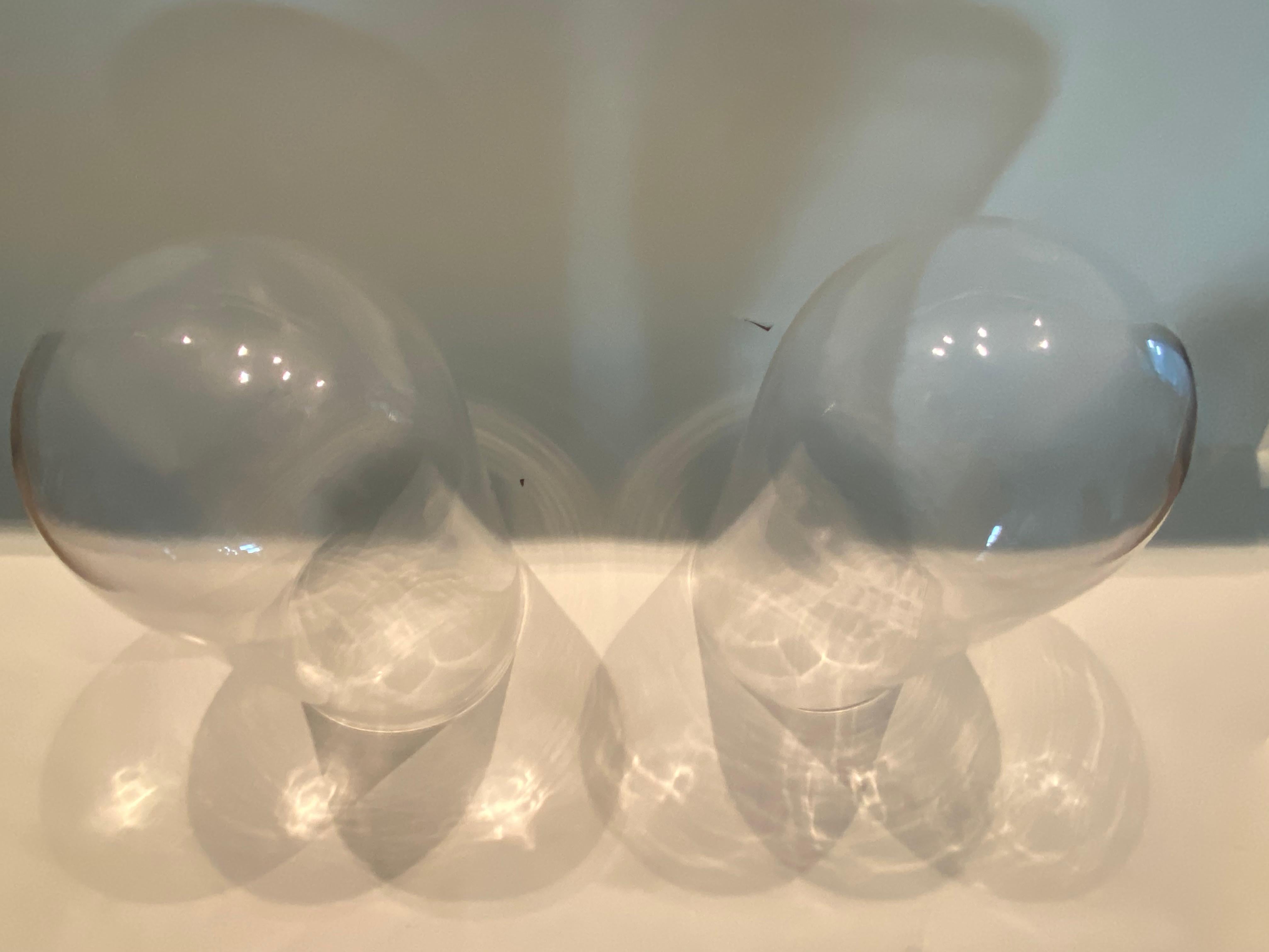 This pair of tall glass display domes or cloches are perfect for showcasing fragile artworks, watches or botanicals.  The photographs appear dark, but these domes are clear glass.