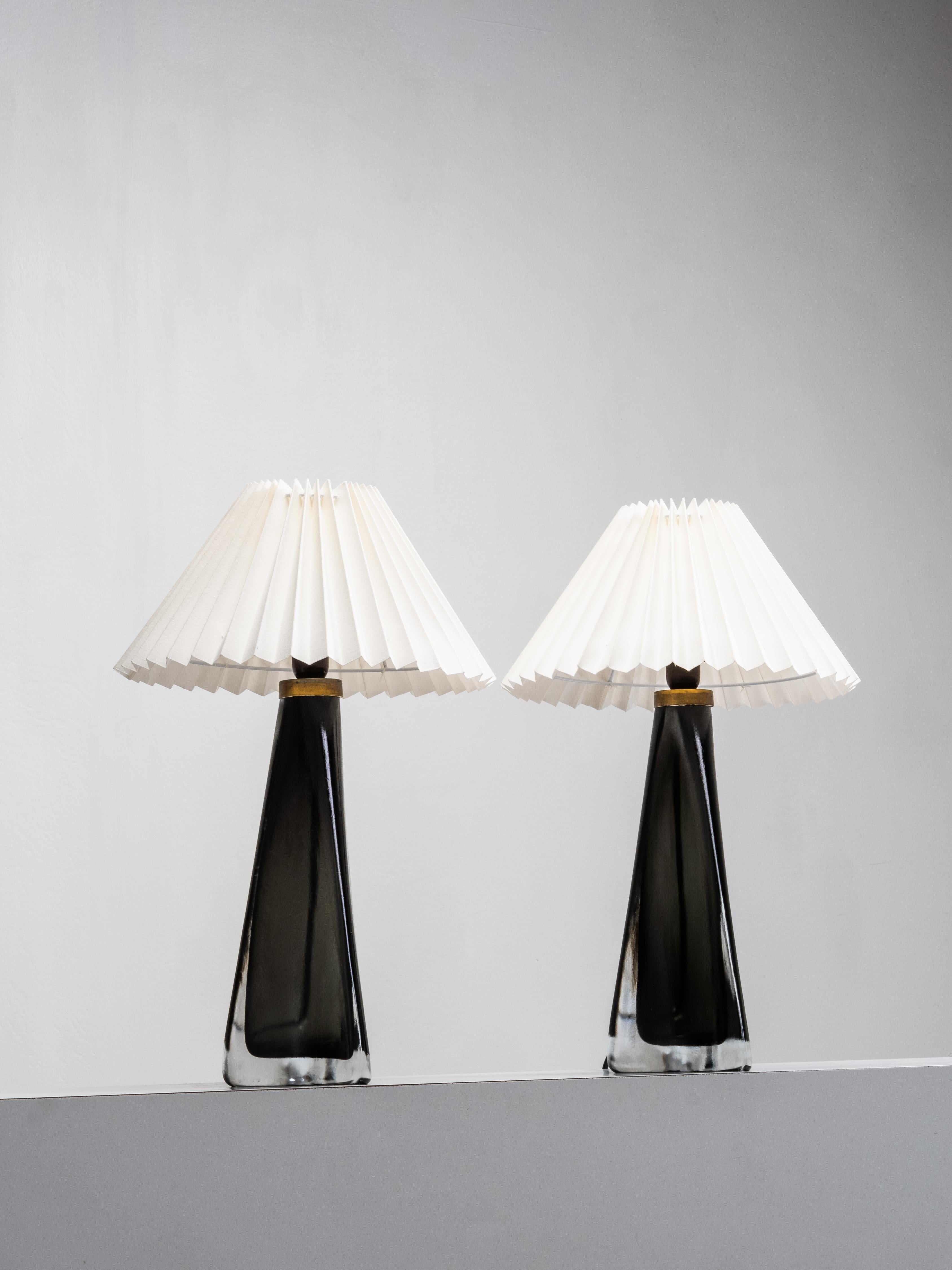 A rare pair of large table lamps designed by Carl Fagerlund for Orrefors, model RD 1319. Each lamp features a sculptural glass form with an internal smoke-grey tone encased in thick clear crystal, its surface subtly etched to enhance depth and light