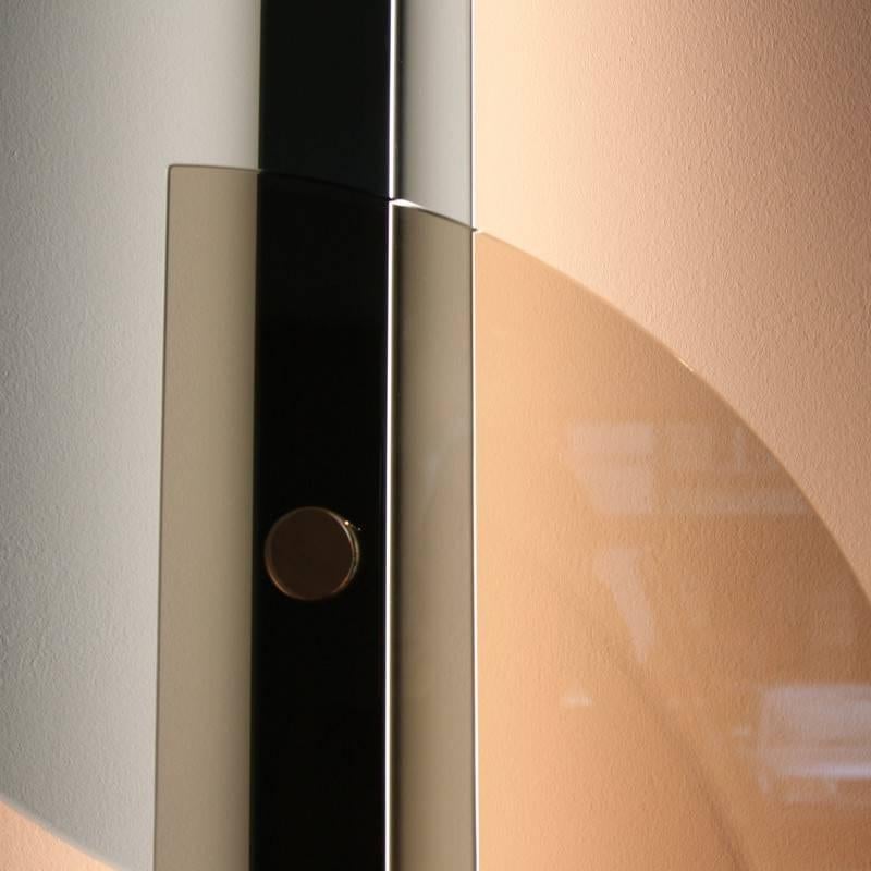 Beautiful large wall sconces designed by Bernhardt & Vella for Arflex in 2016. They come in two different color variants: pink / grey and light blue / bronze tempered glass. The structure is gold.

The image shows variant 