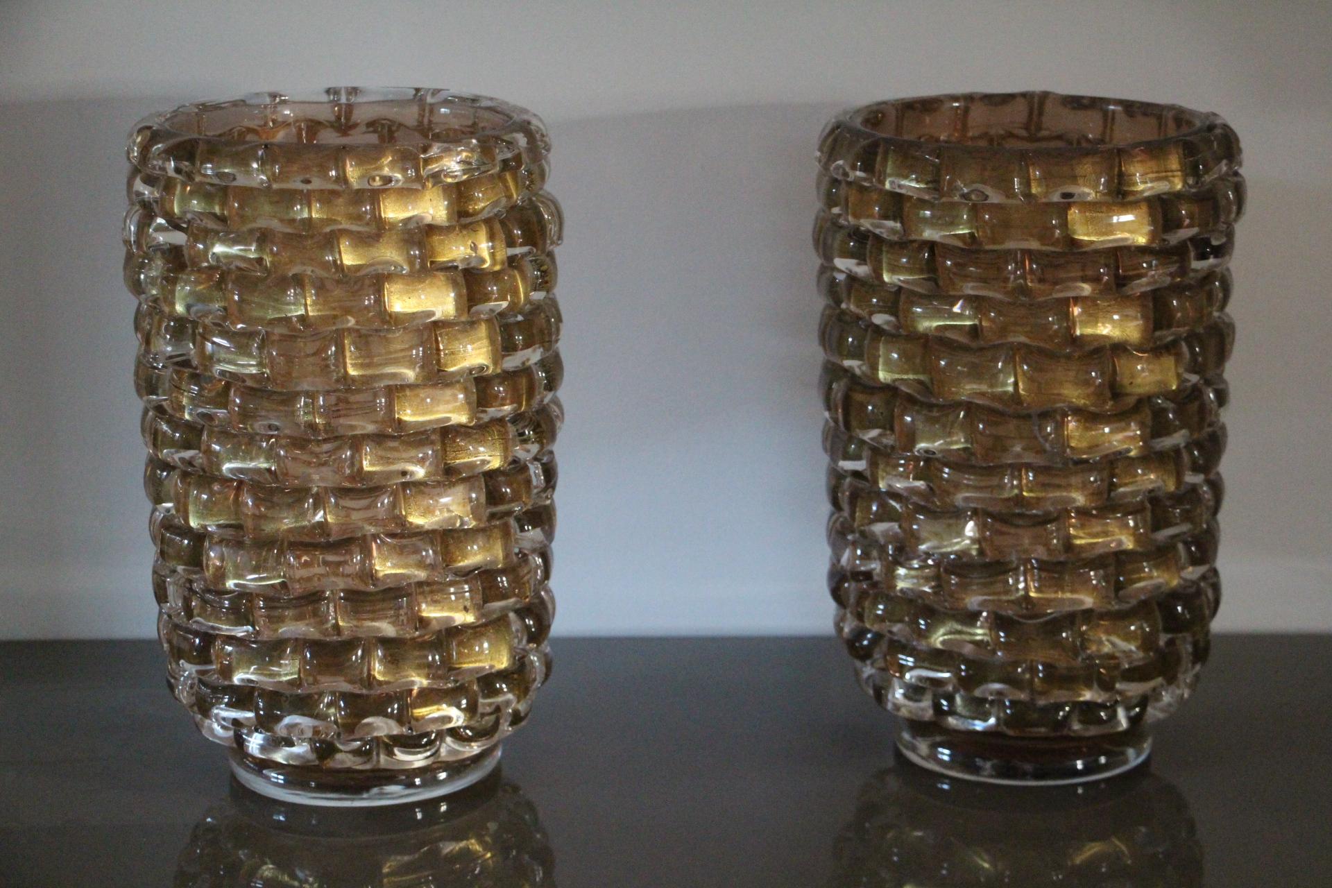 This spectacular pair of vases has got a very unusual iridescent color that goes from deep gold to a kind of pink gold according to surrounding colors and light.
Moreover they were entirely made by hand in Venice thanks to a very special technique