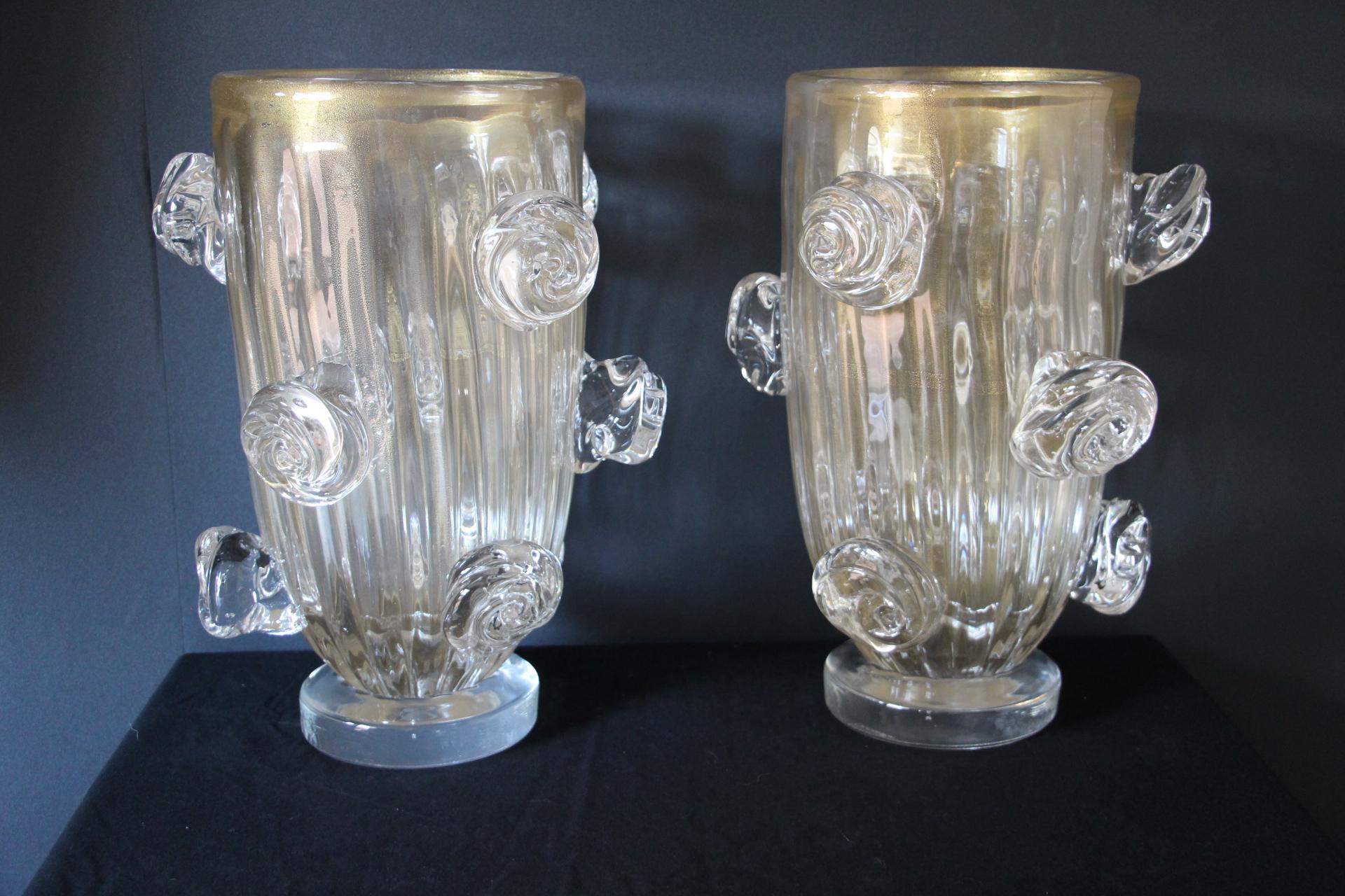 This spectacular pair of vases has got a very unusual golden color that goes from deep beige to light gold according to surrounding colors and light. This special effect is due to gold dust inclusions in glass.
Moreover they were entirely made by