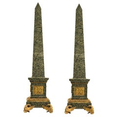 Pair of Large Granite and Gilt Bronze Figural Obelisks