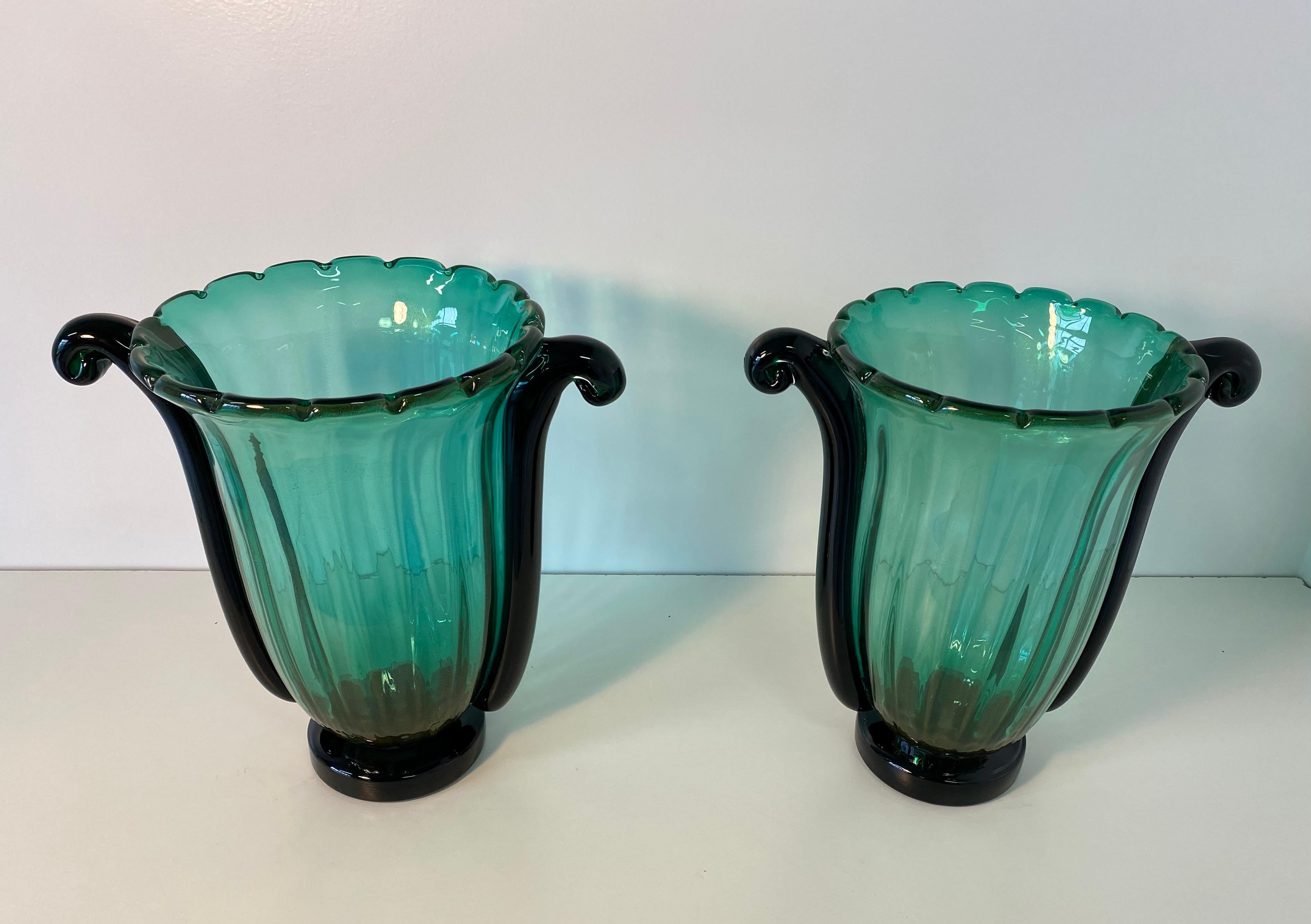 Elegant and rare Art Deco style vases produced in Murano by Cenedese.
They are in green glass with shades of gold leaf inside while the base and the two side parts are in black glass.