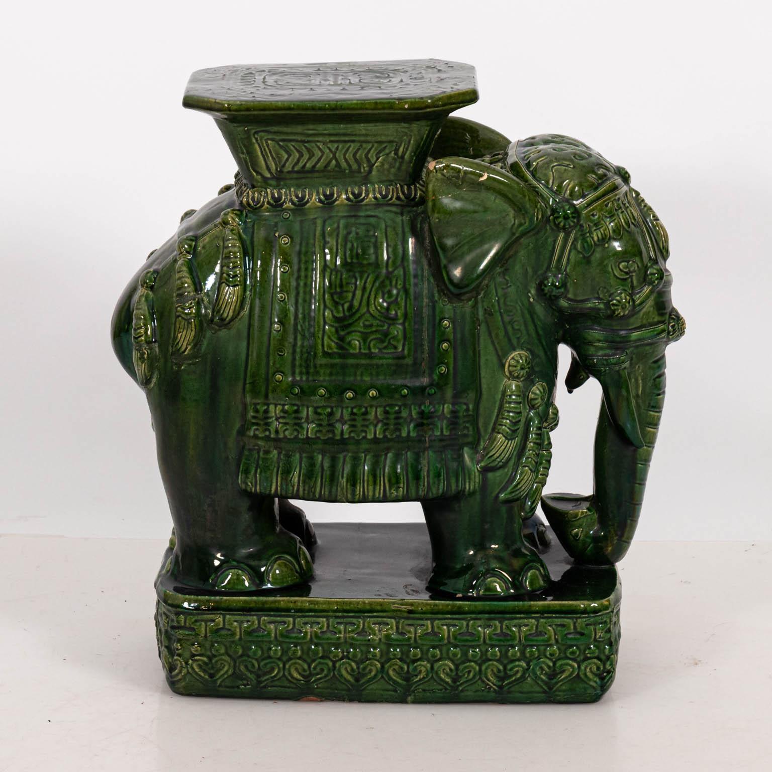 Pair of large green glazed terracotta garden seats in the shape of Elephants, circa 20th century. Please note of wear consistent with age including finish loss and minor chips.