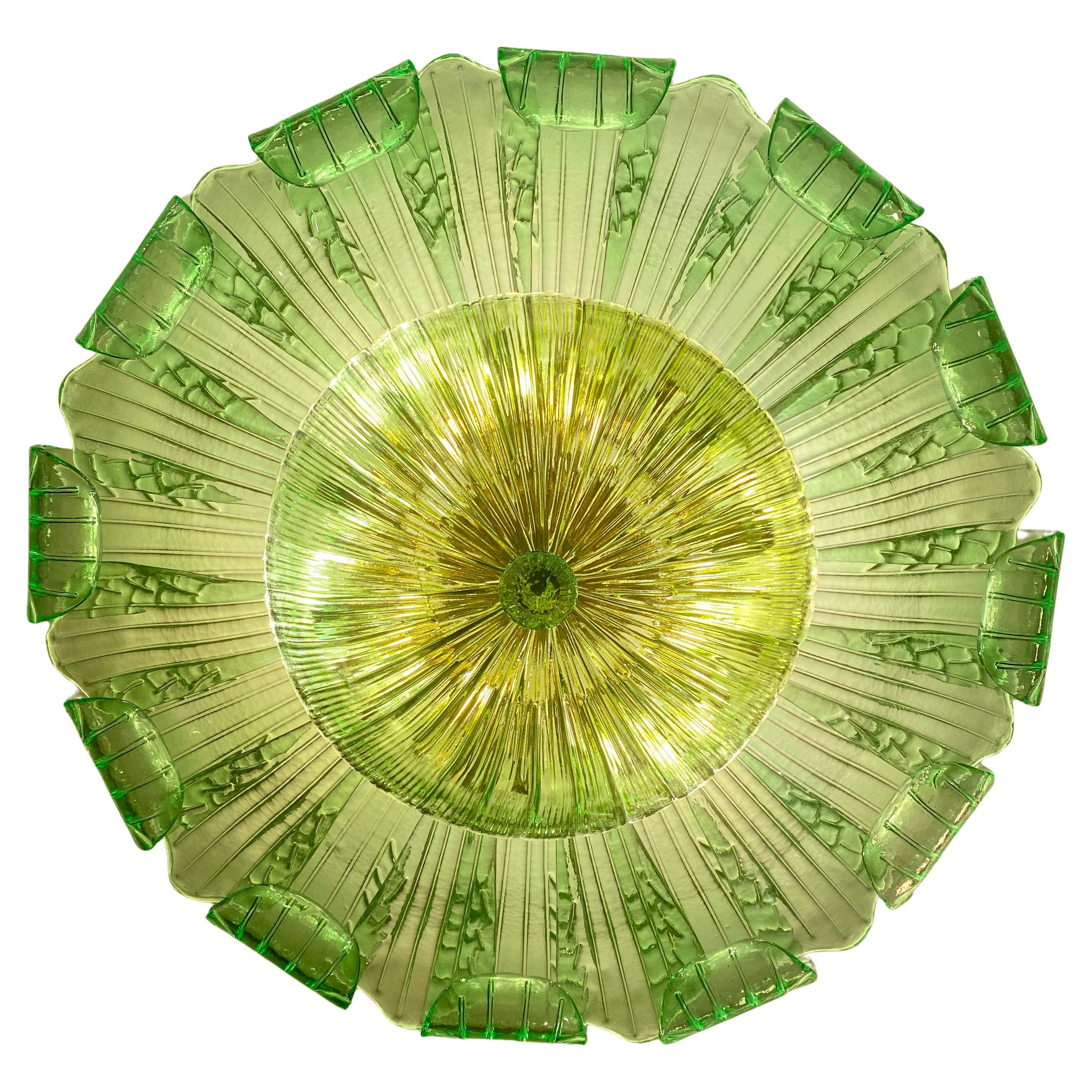Realized in pure Emerald green color Murano glass consists of 24 large hand-blown leaves.
 The structure is gilt-metal. Nine E27  lights bulbs  spread a magical light.
 Wattage 4-6 W 
 Weight ; 28 kg

Available also a pair.
This light fixture can be