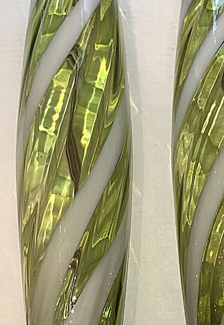 Pair of circa 1960's Italian blown glass Murano lamps in a pale lime green color with swirled white ribbon.

Measurements:
Height of body: 24