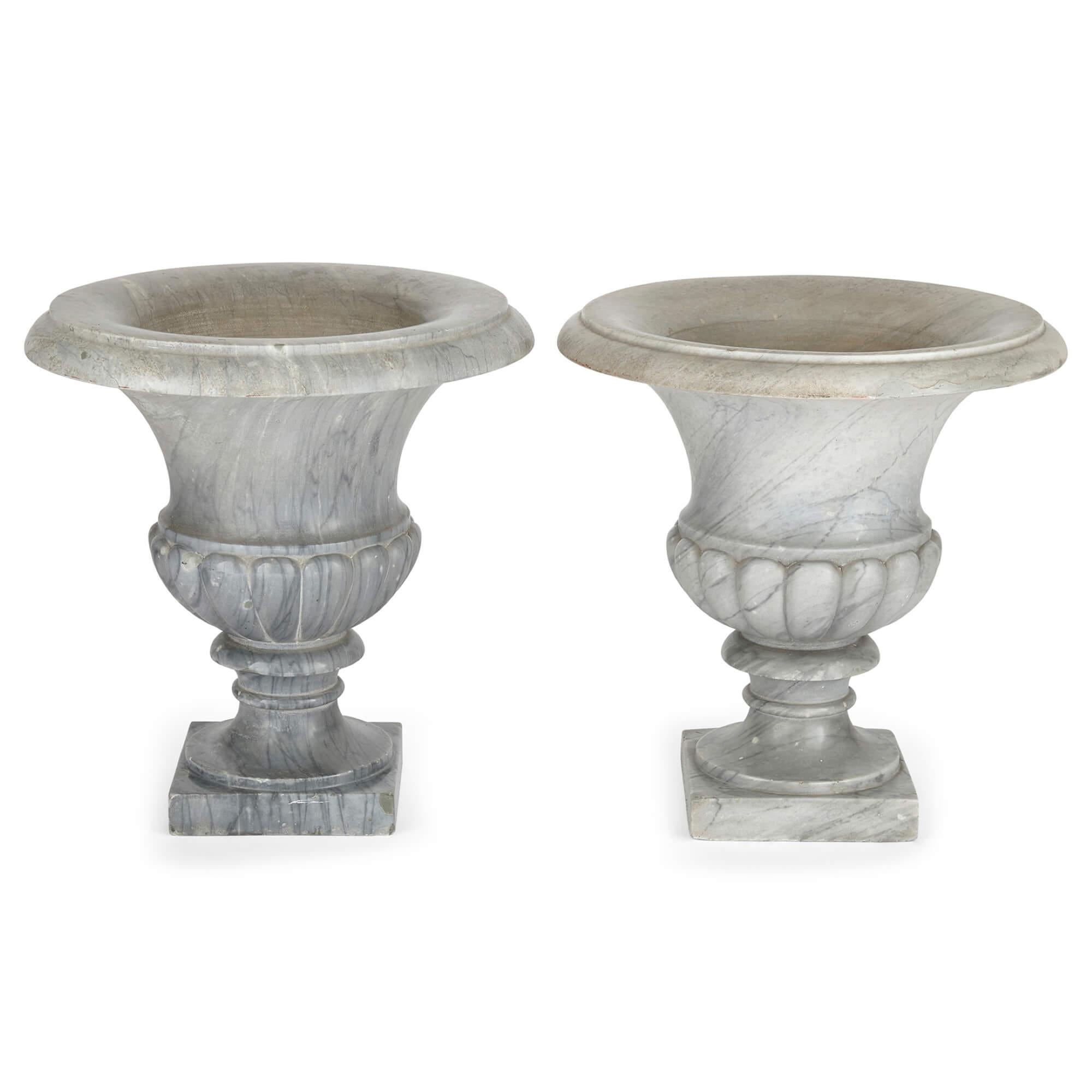 Pair of large grey marble Neoclassical Campana form garden vases
Continental, late 19th century
Measures: Height 46cm, diameter 44cm

These fantastic pieces are a pair of large neoclassical garden vases, carved from grey marble in the familiar