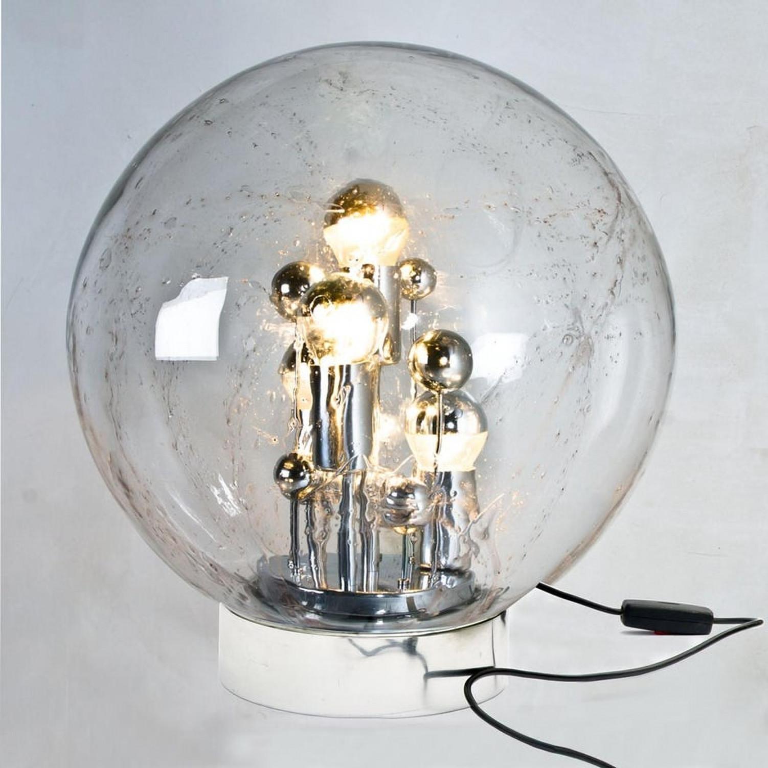 Pair of enormous Doria hand blown glass sphere on chrome base lamps, Germany, circa 1970. This exceptional artefact of modern design reflects the extreme interest in modernism across Europe during this period. This unique lamp not only functions as