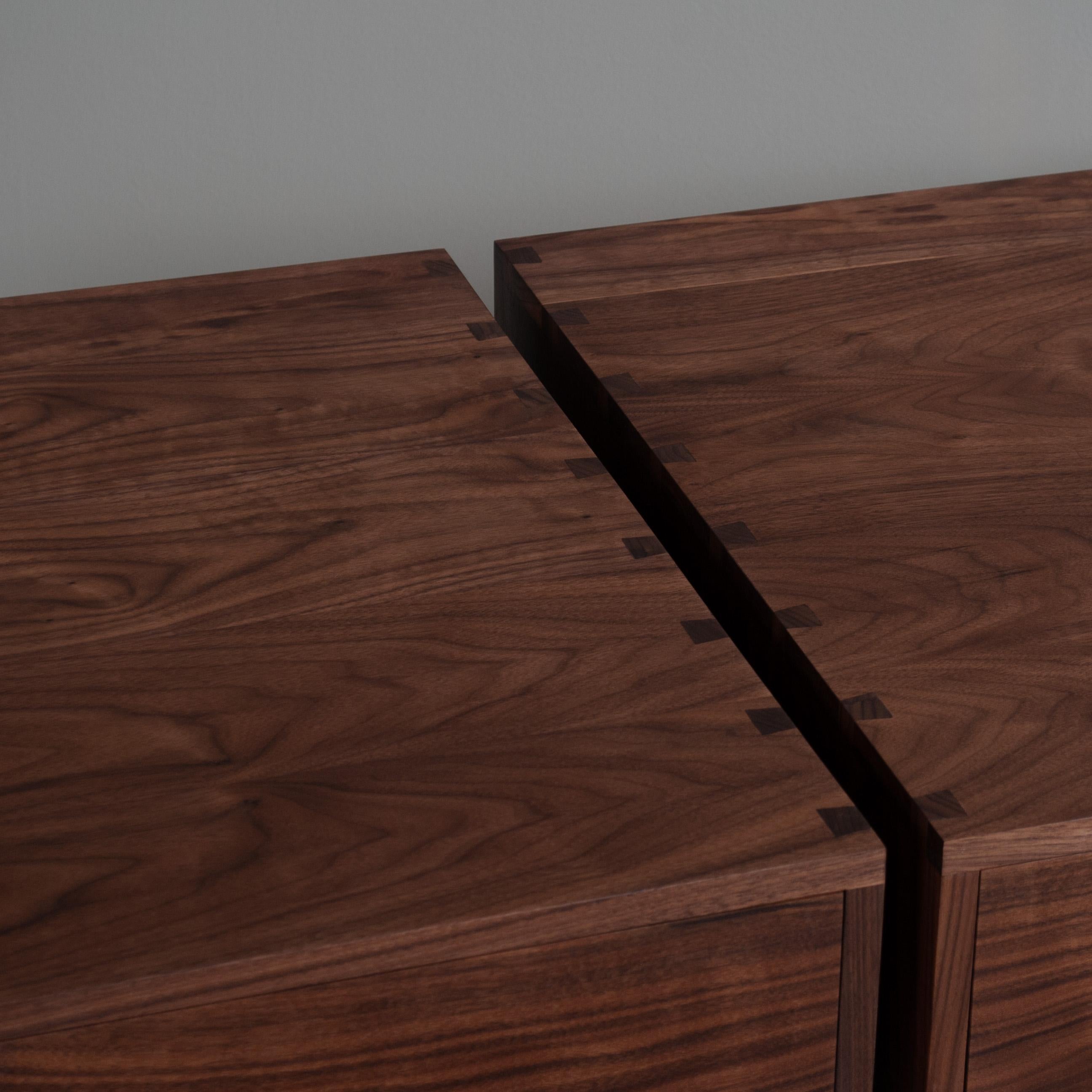 A pair of large walnut hand-crafted nightstands or end tables. Constructed from finest American black walnut with the inner dovetailed jointed drawer carcass in English quartersawn Oak. The upper box is detailed with hand-cut dovetail jointing. A