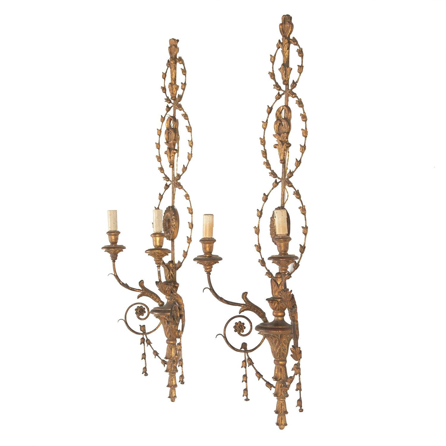 Pair of large Italian 19th century wall lights with carved gilded wood and metal. The wall lights each have two arms, and have been rewired and PAT tested to UK standards.