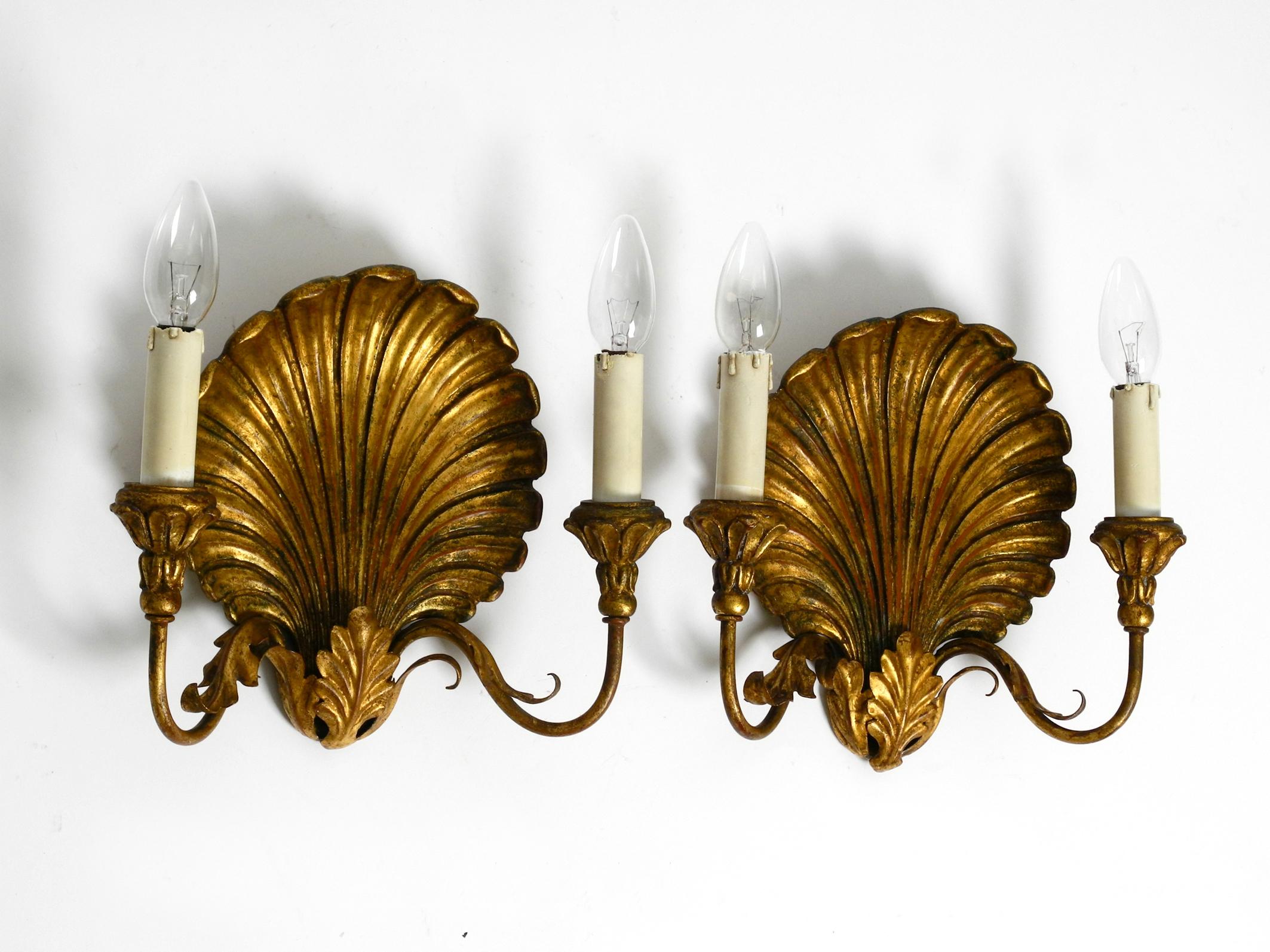 Pair of extravagant Italian large 2-armed Mid Century wall lamps by Palladio.
Palladio was an Italian manufacturer of high-quality lighting.
The original labels with the logo and date of manufacture are still on the back of both lamps. Made in Italy