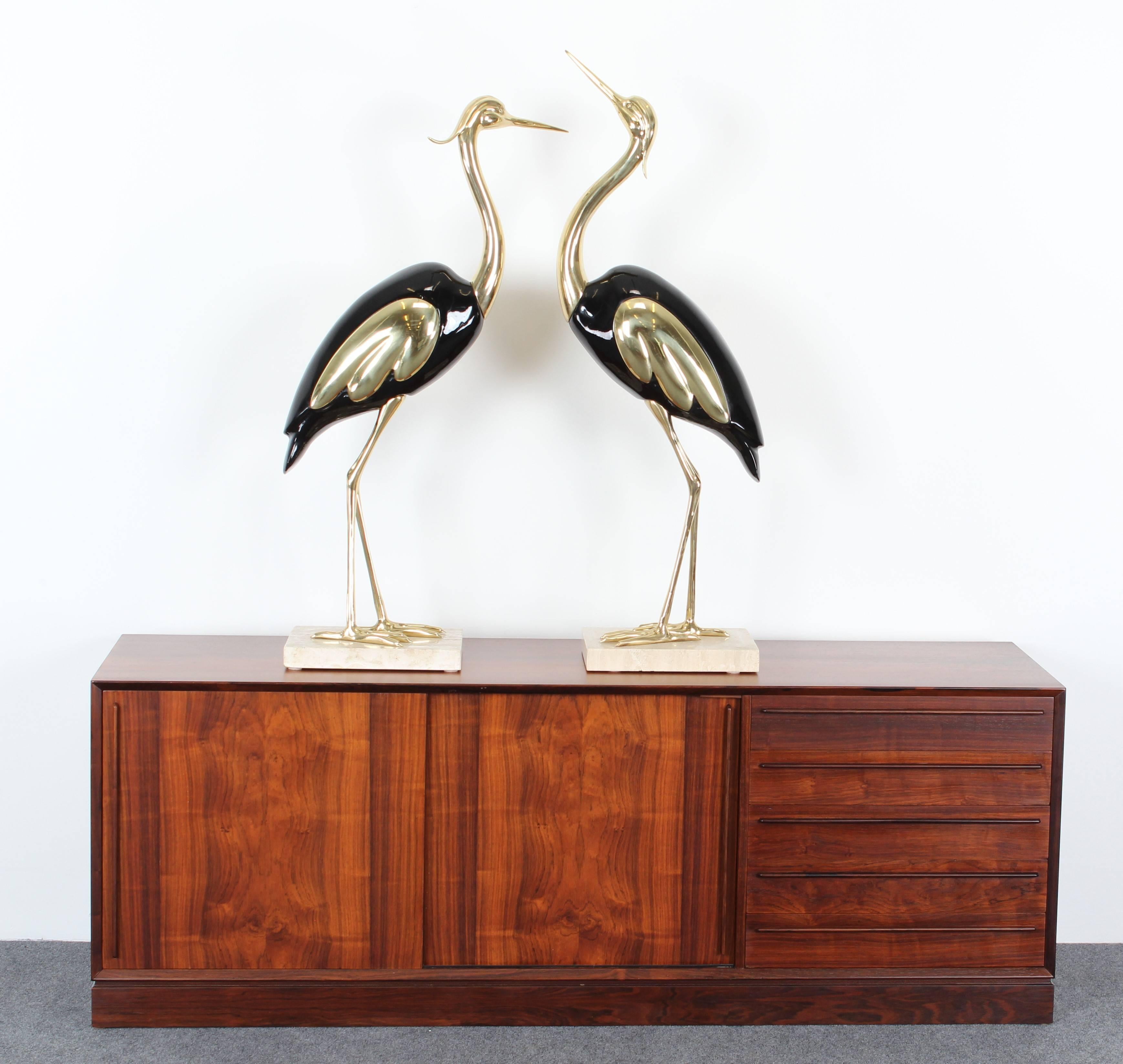 A pair of large Italian lacquered and brass Egrets or cranes on a travertine marble base. Very good condition with age appropriate wear. 

Dimensions:
1: 42.25
