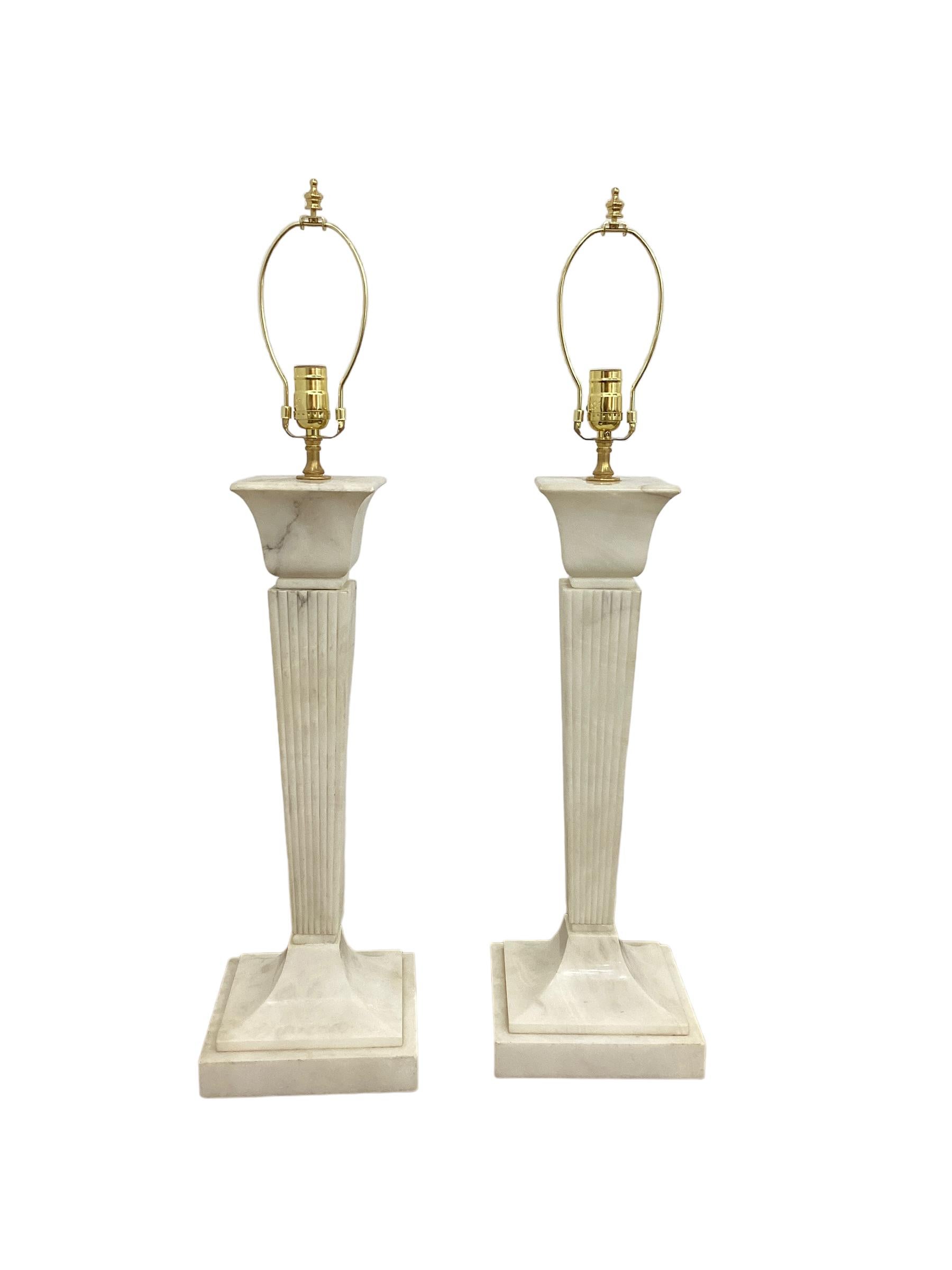 A Pair of Large Art Deco Alabaster Lamps with tapering reeded columns. These lamps are quite impressive and stately in presence. They measure 24” to the top of the column and the base is 8.5”square. They have been newly wired and are in good working