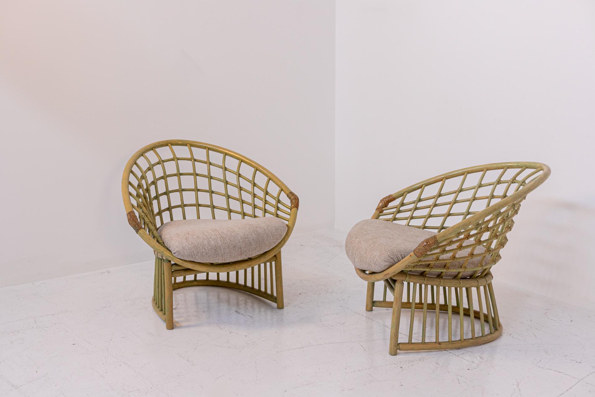 Beautiful pair of Italian bamboo armchairs from the 1980s. The armchairs are made from bamboo and rattan reeds. Their enveloping but also angular shape seems to resemble a diamond because of the interplay of weaves created by the bamboo. The base of