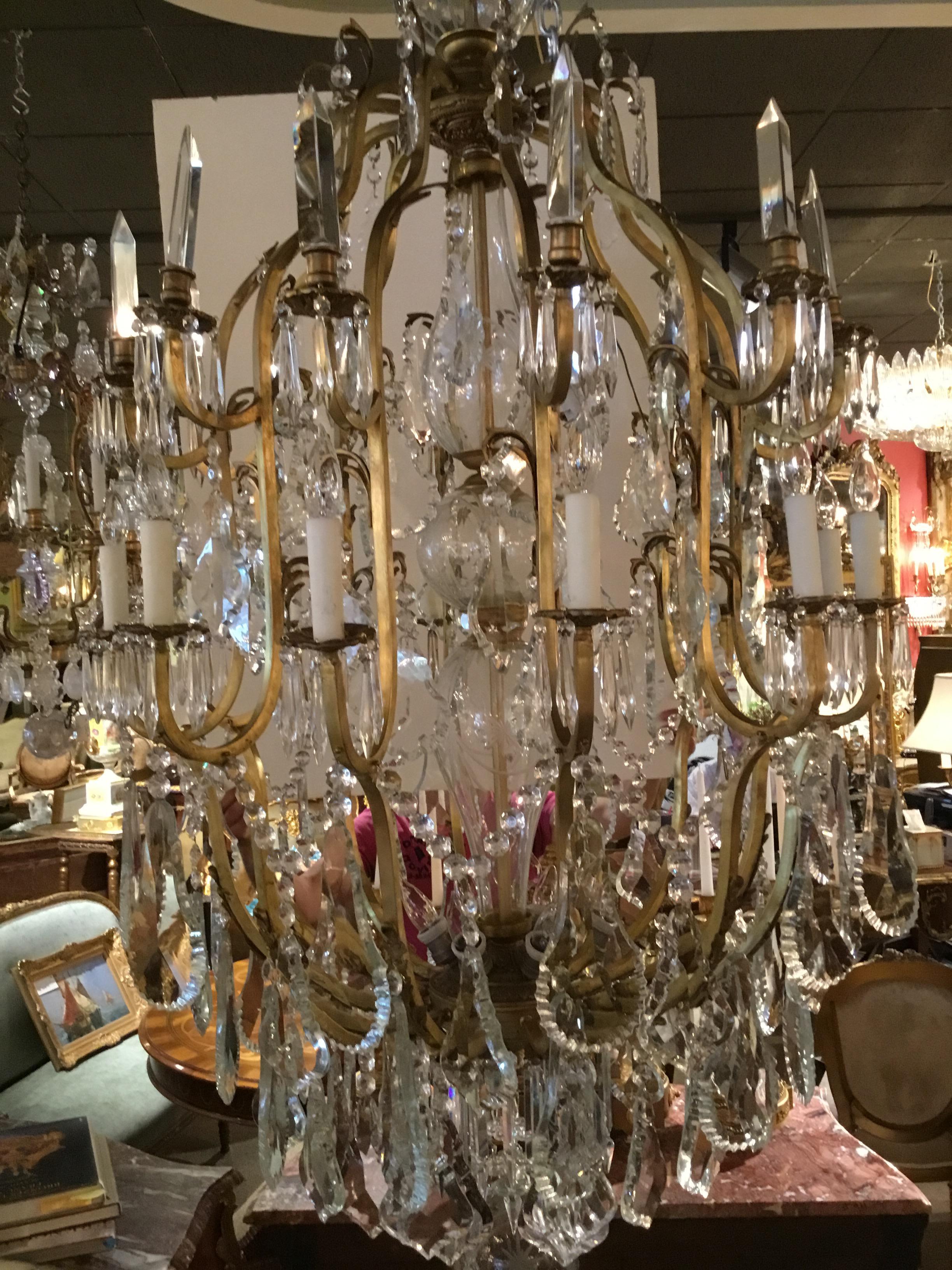 Beautiful and large-shaped crystals that are very clear with 12 lights on the perimeter of the well shaped frame. Scrolling arms
And 6 up lights and one down light at the crown. Spires are 
Around The perimeter to adorn these pieces. Large