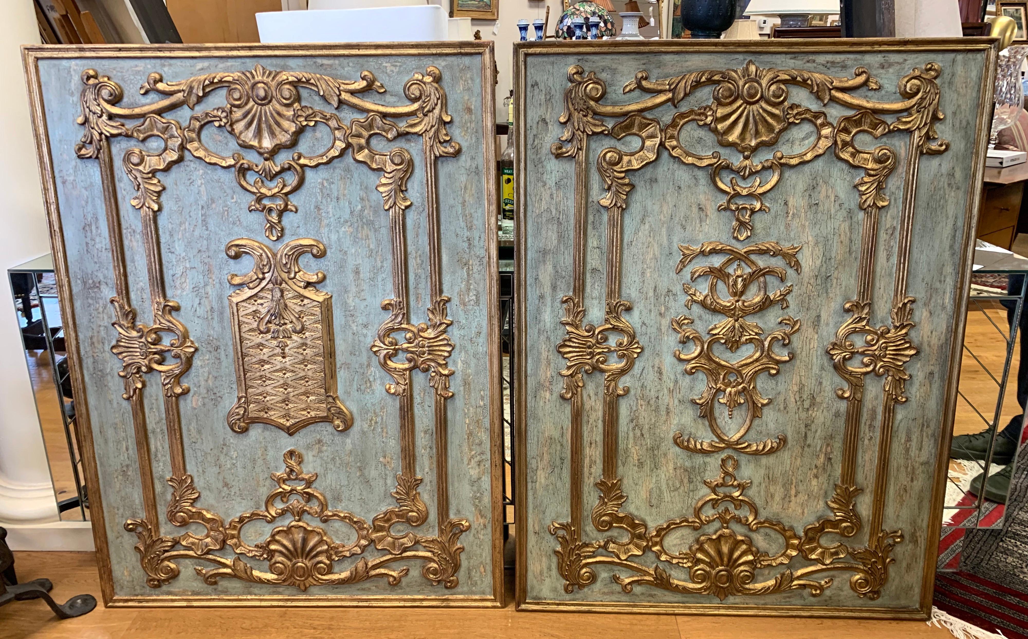 Pair of stunning Italian boiseries panels, carved wood and gilt with patinated light blue paint.
