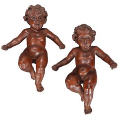 Pair of Large Italian Carved Walnut Figural Wall Sculptures of Cherubs