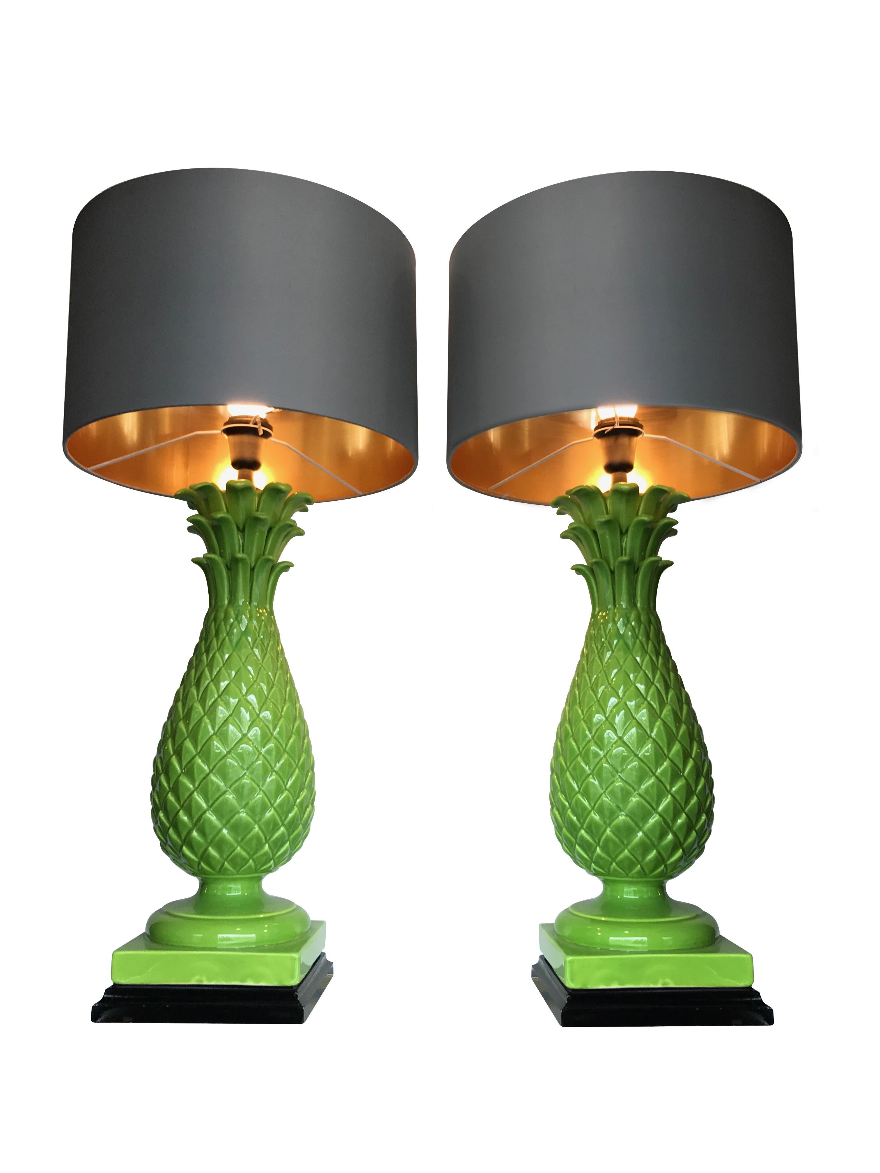 A pair of large Italian ceramic green pineapple lamps with black bases. Rewired with new chrome and black fittings, black antique cord flex and new switches. With new bespoke slate colored shades with gold linings.
 