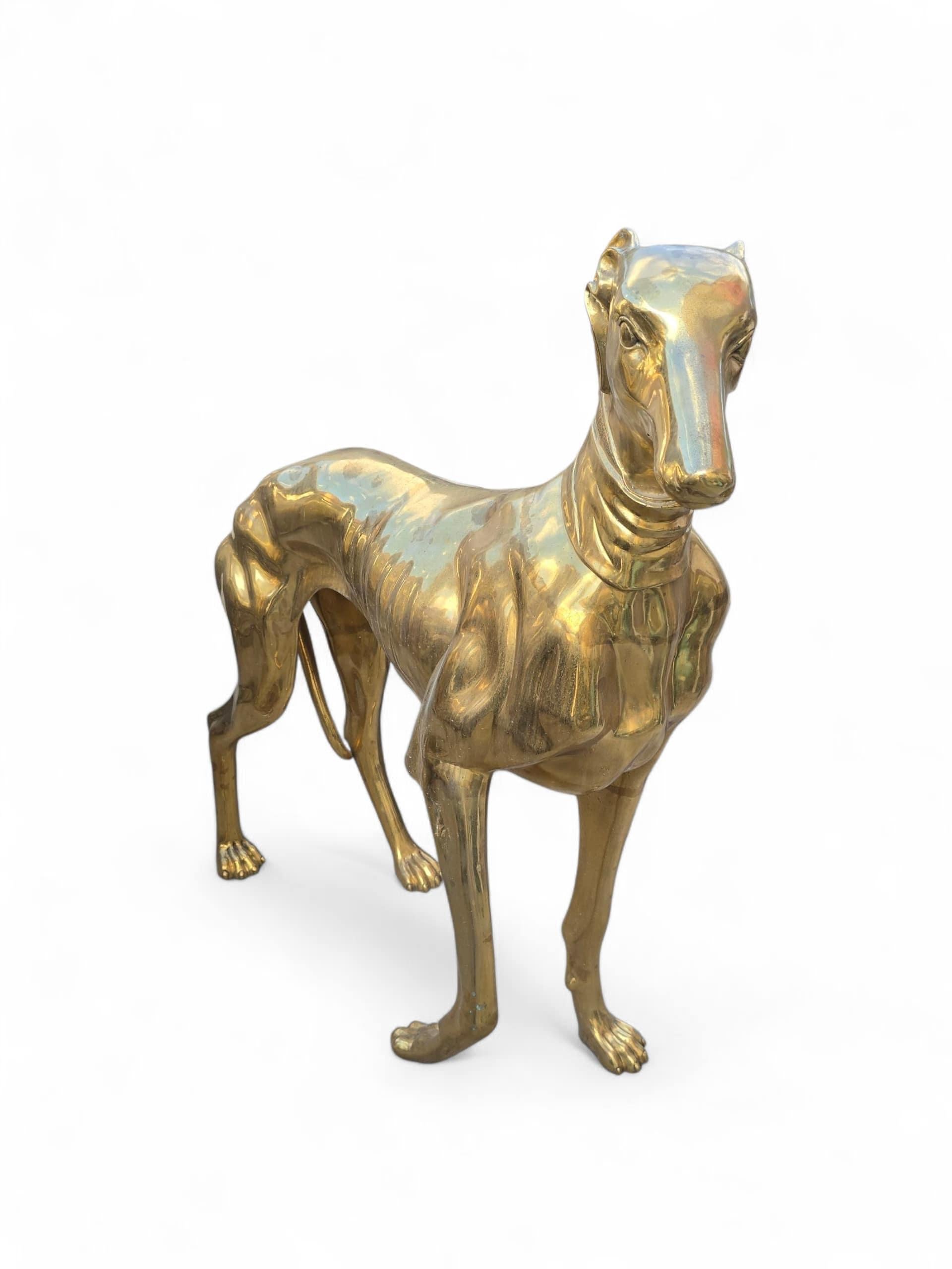 Elegant and finely cast pair of large Italian dog sculptures in gilded bronze, made with exceptional attention to detail and form. The figures are portrayed in noble poses with lifelike expressions, reflecting both strength and elegance. The rich