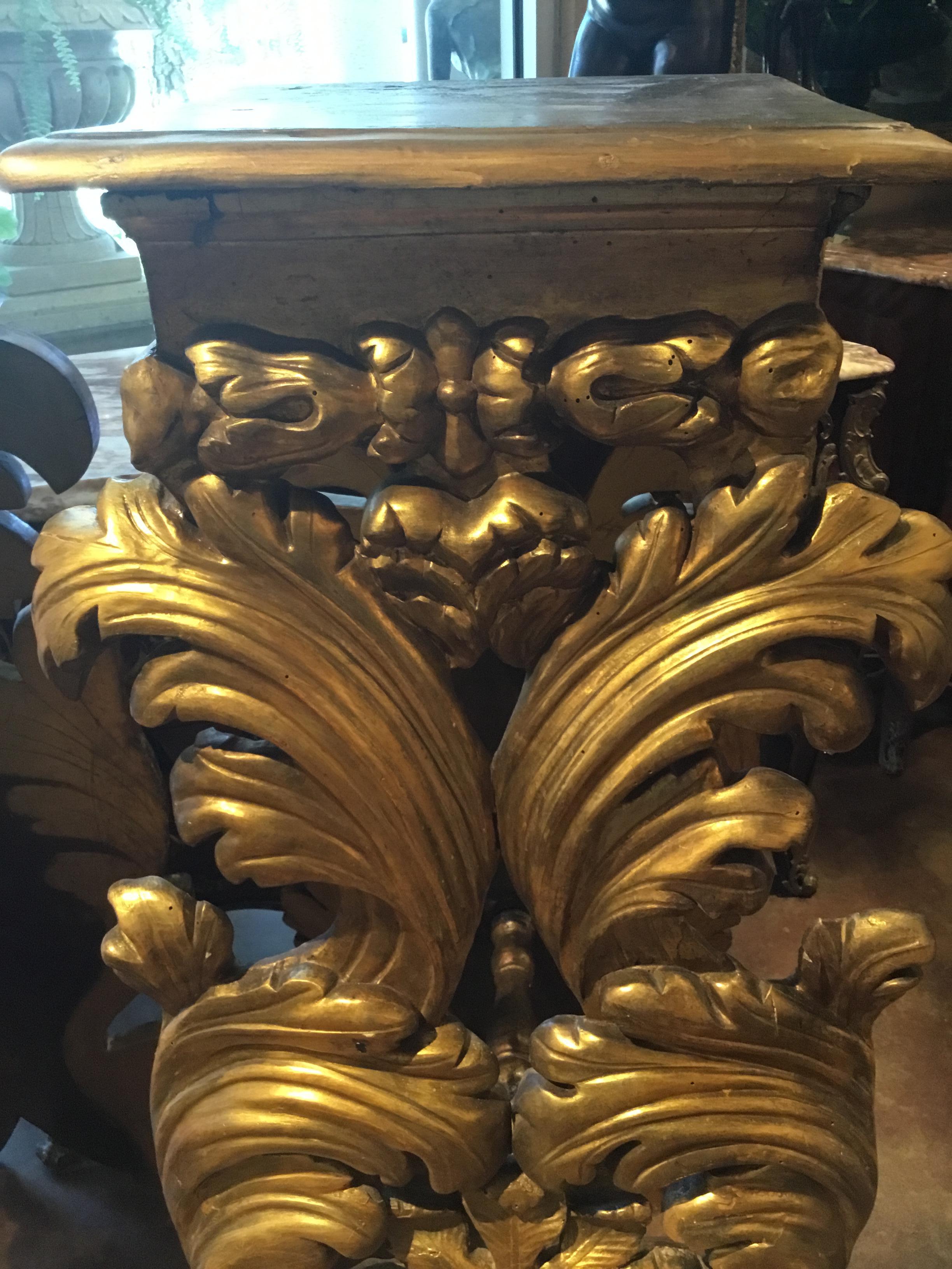 Beautifully carved and gilt old world pedestals with exceptional carving.
Swirling curves that are carved form the front of these pieces. A flower
and foliate design is centered on the front. The front is connect to the
back piece by a stretcher.