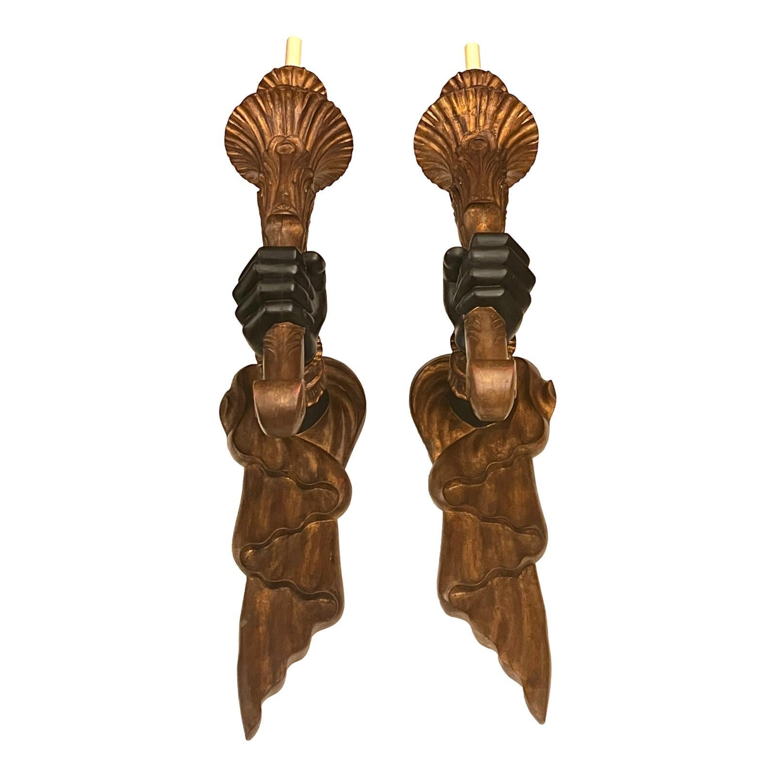 Pair of circa 1960's Italian carved and gilt wood sconces with arm holding light.

Measurements:
Height: 38