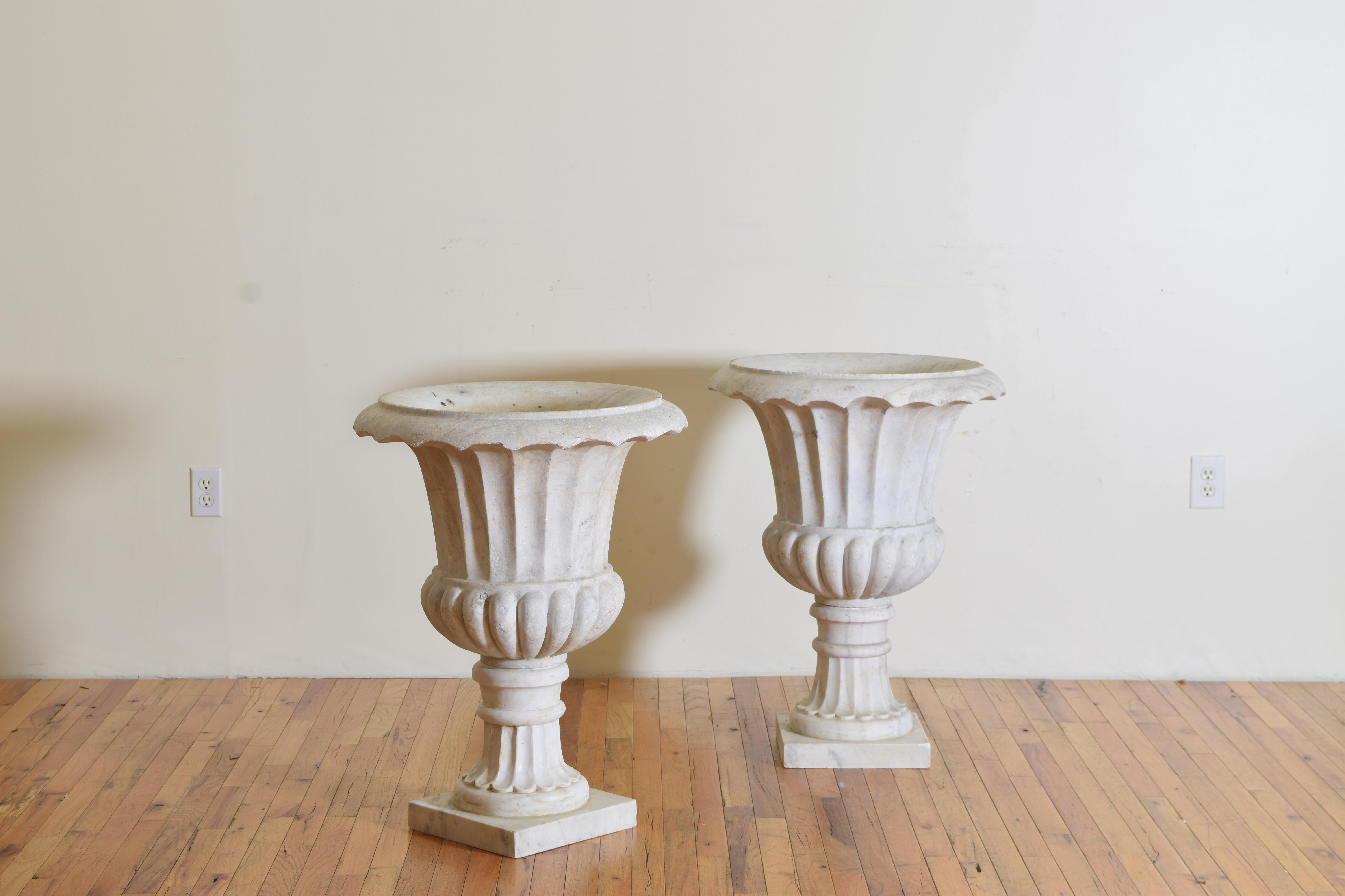 Carrara marble and from Genoa, Italy these two-piece urns are hand-carved and very solid, from the late 18th to early 19th century.