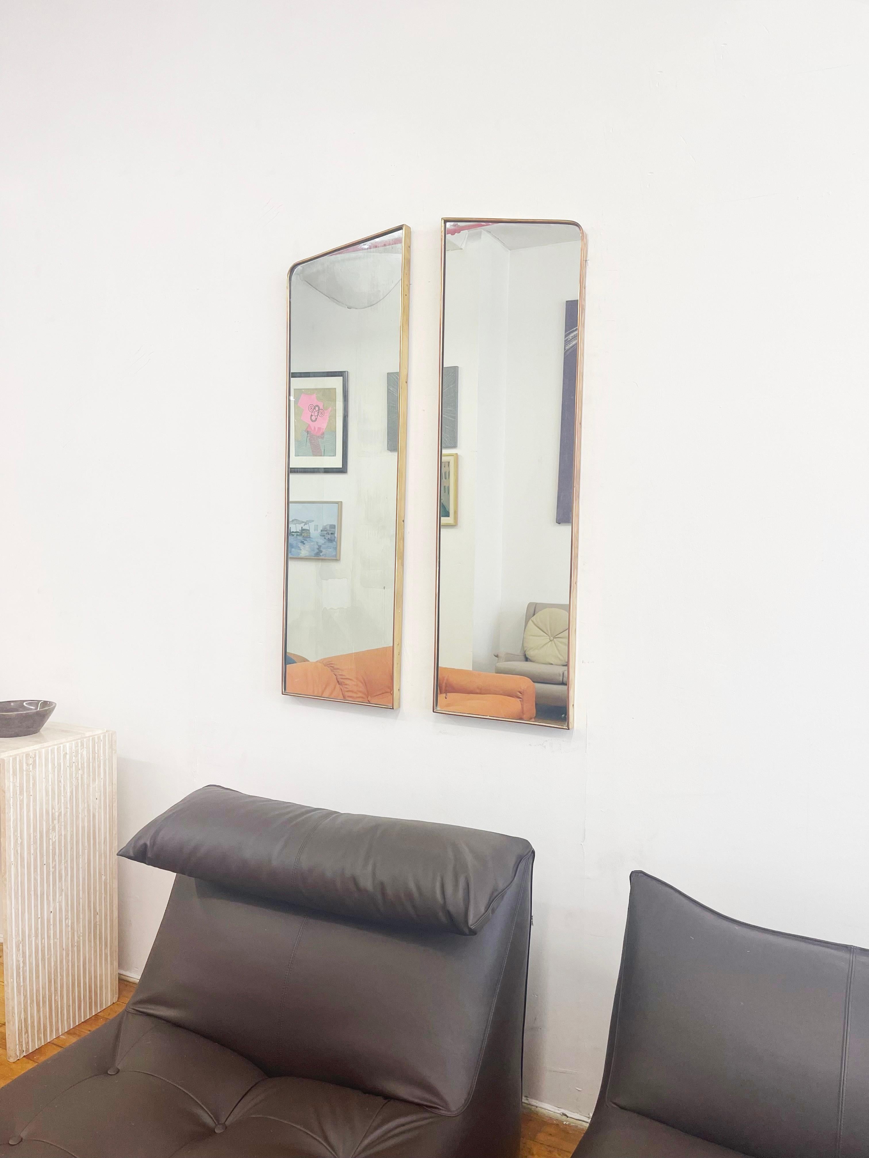 Introducing a stunning duo of Italian Vintage Brass Frame Mirrors, exuding a sleek and towering presence that instantly captivates. These mirrors are masterfully crafted with symmetrical shapes, designed to be used in perfect harmony as a