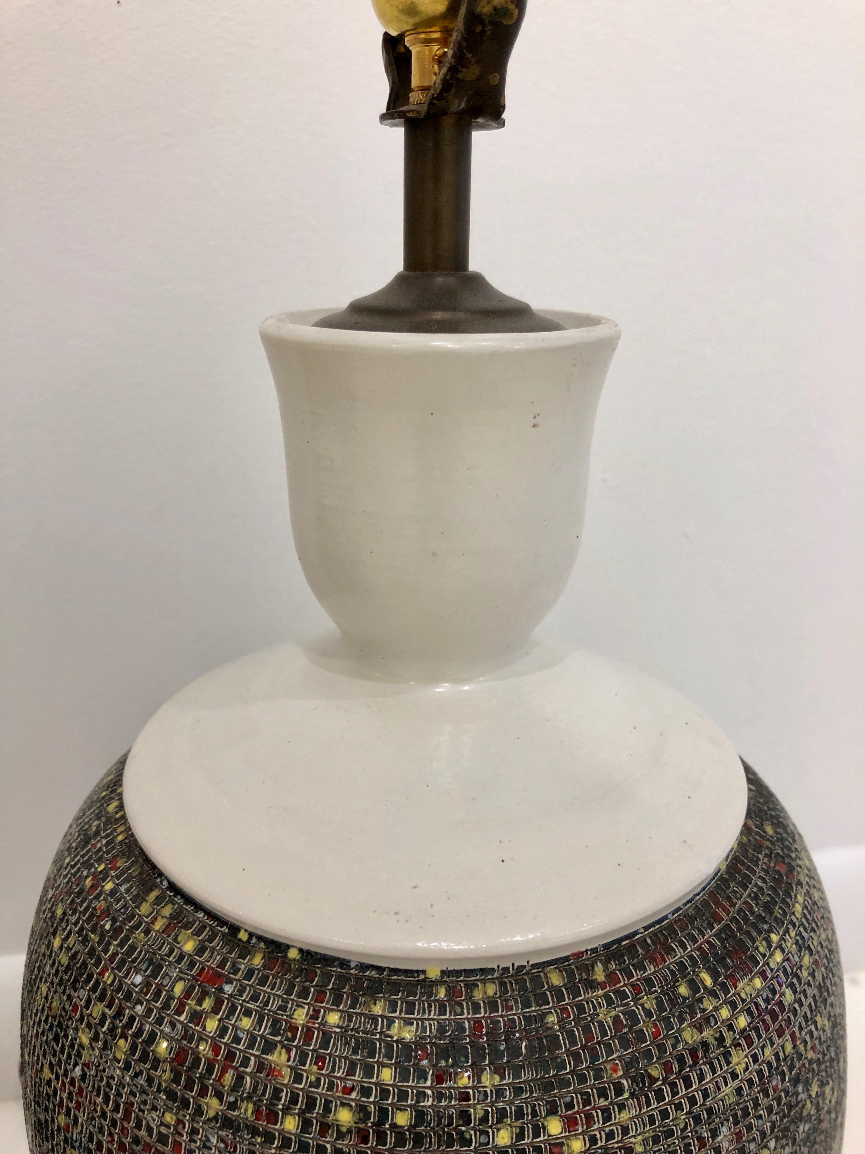 Bottle-form pottery bases with hand-incised and decorated surface. A sgriffato grid is overlaid with multicolor dots, creating an earthy yet almost mathematical landscape. Shades not included. Signed 