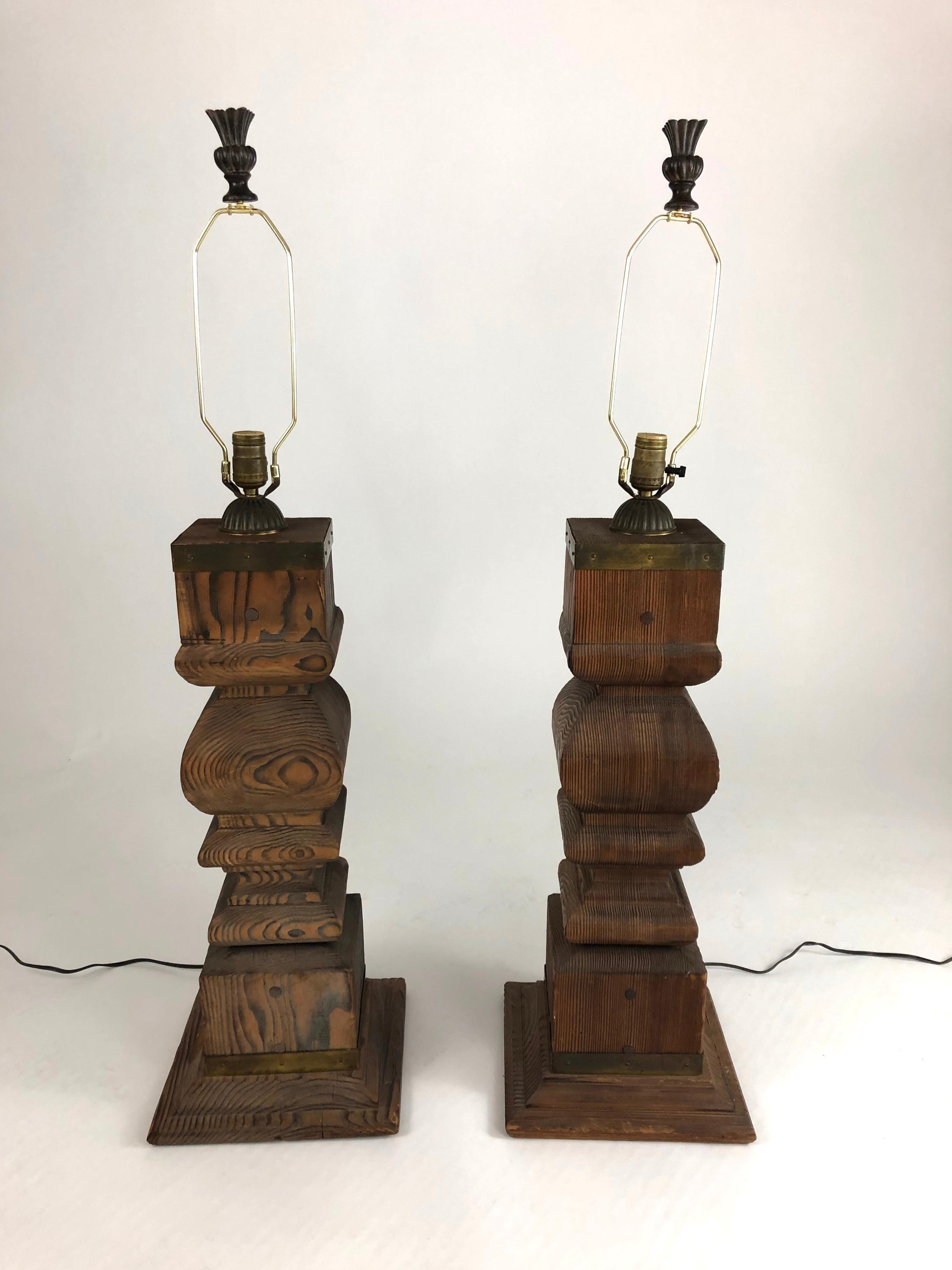 A pair of large, architectural Japanese solid cypress wood baluster lamps with brass trim. Organic and sculptural, the wood of these lamps has a wonderfully textural graphic quality.
Shades with diffusers and finials included, if