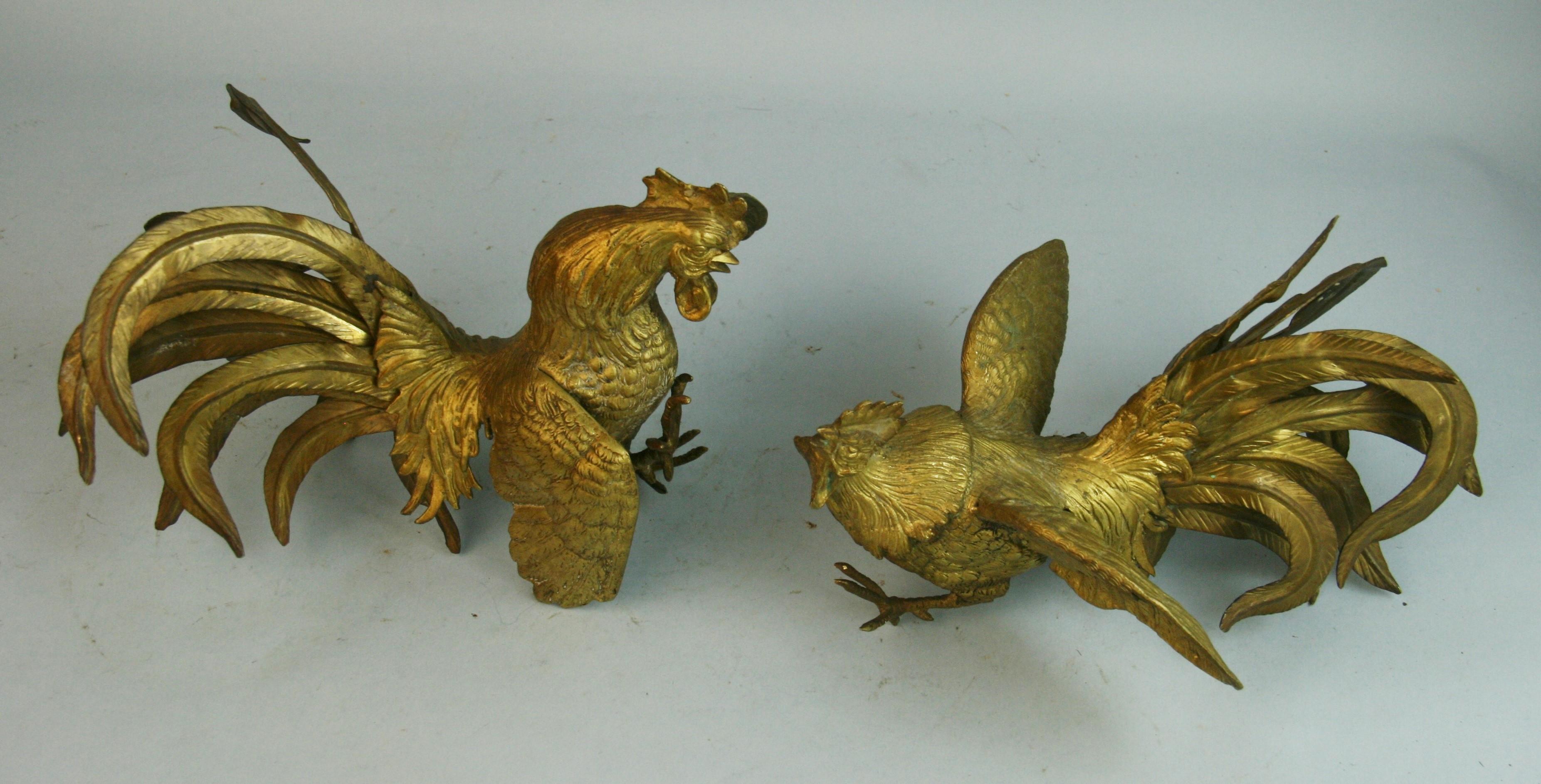 Japan, great pair of fighting cocks sculpture. These animated bird sculptures bodies are hand cast by a master craft man and the tail feathers are hand tooled with exquisite details, each has a great patina.