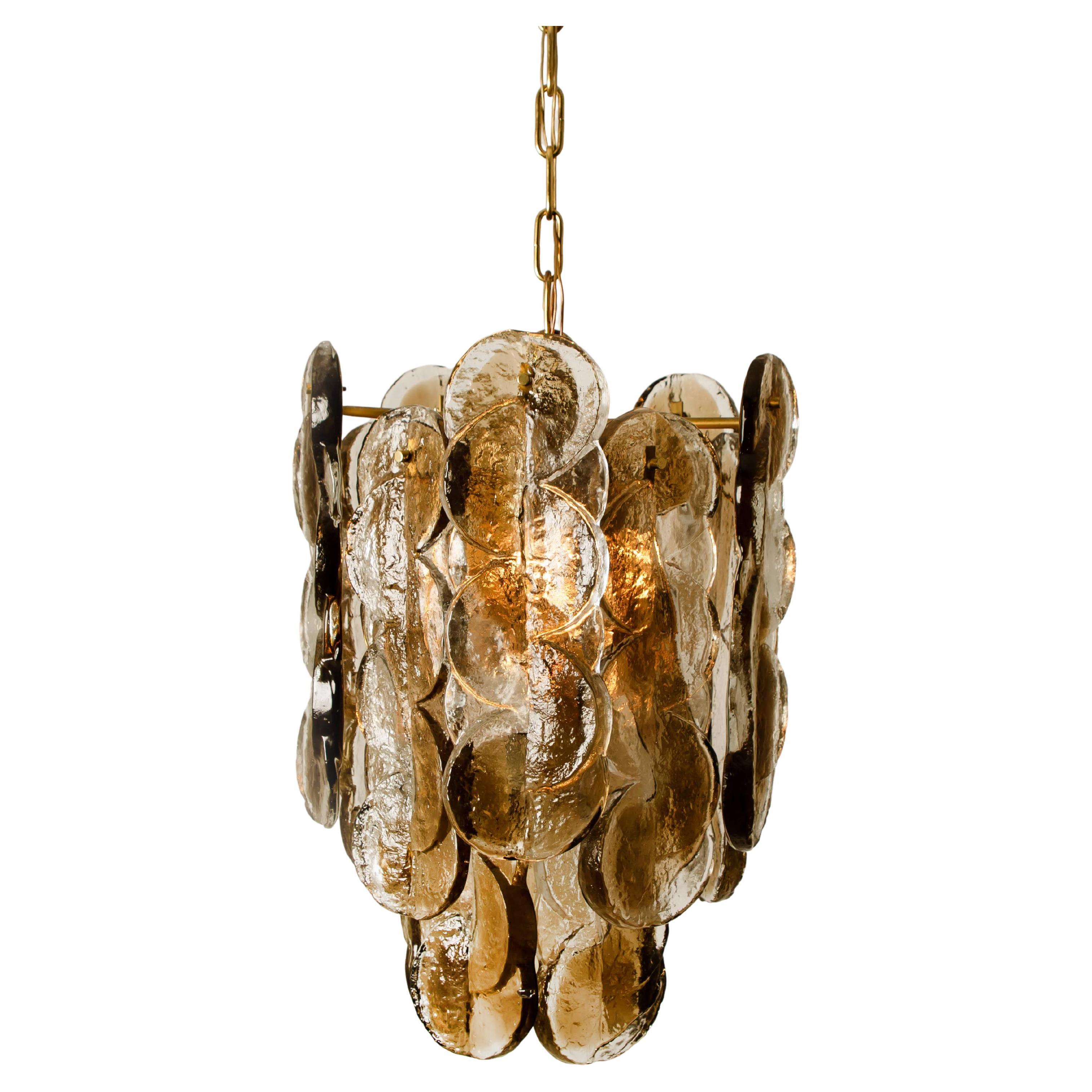 Pair of high quality murano glass chandeliers by Kalmar, 1960s smoked swirl ice glass, clear twisted crystal glass panels with a light gold dish amber colored stripe in it.

Kalmar was the most important producer of premium-quality chandeliers in