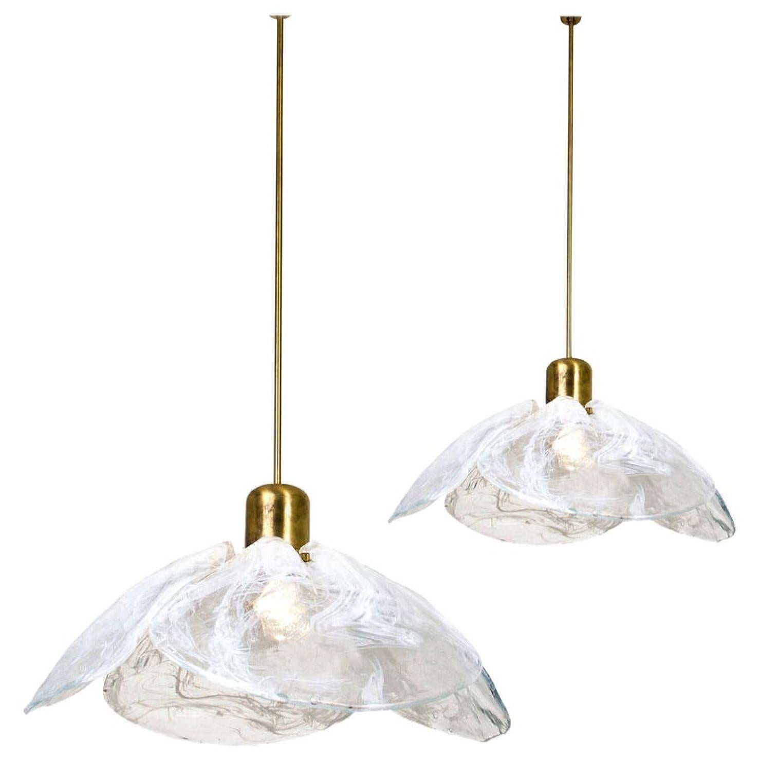 Two beautiful high quality midcentury brass chandeliers with four melting glass panels in the shape of a flower. Designed and executed by Kalmar Vienna in the 1970s. Made of hand blown melting clear and white glass.

Cleaned and well-wired, in full