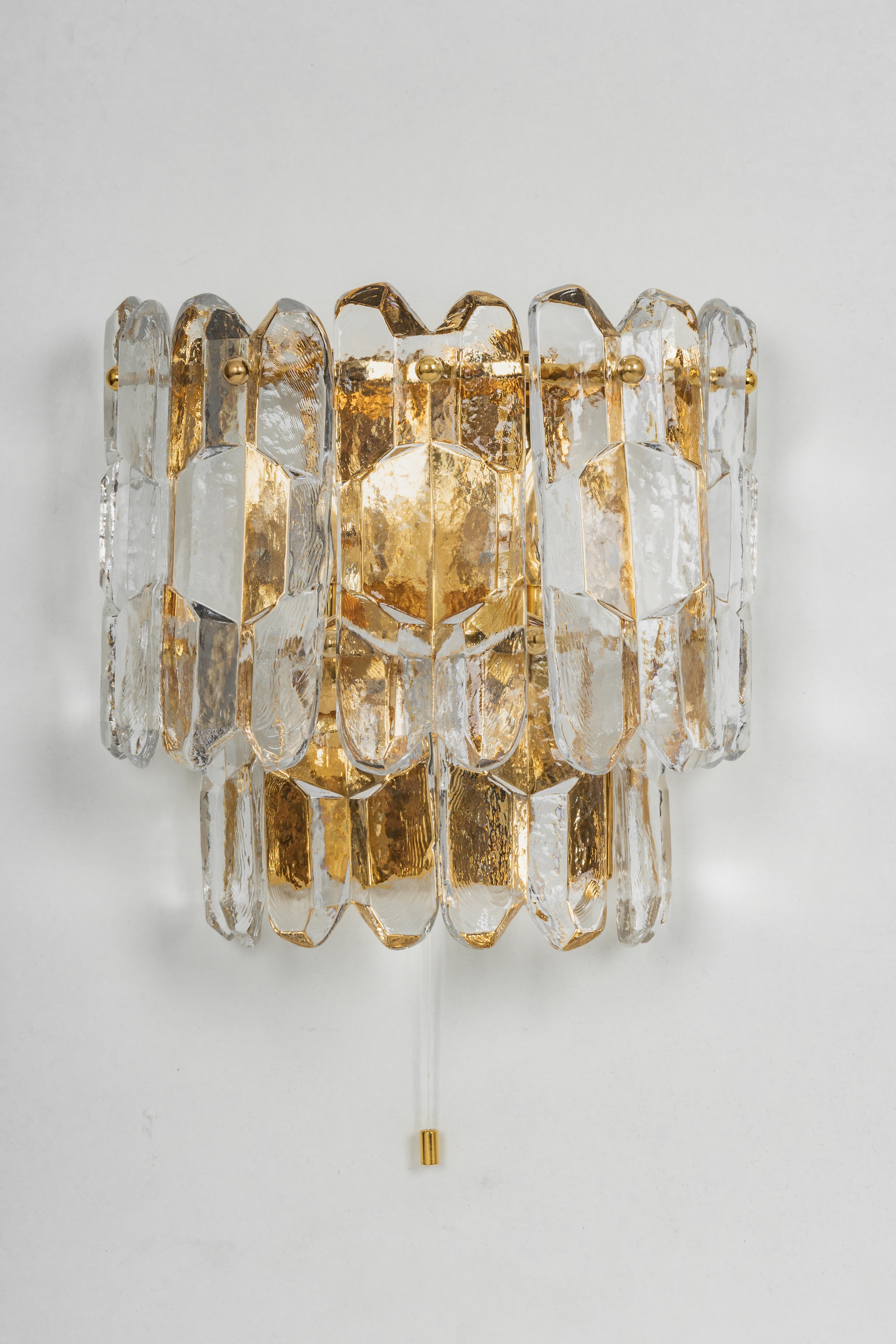 Wonderful pair of midcentury wall sconces with nine murano glass pieces, made by Kalmar, Austria, manufactured, circa 1960-1969.

High quality and in very good condition. Cleaned, well-wired and ready to use. 

Each fixture requires 3 x E14