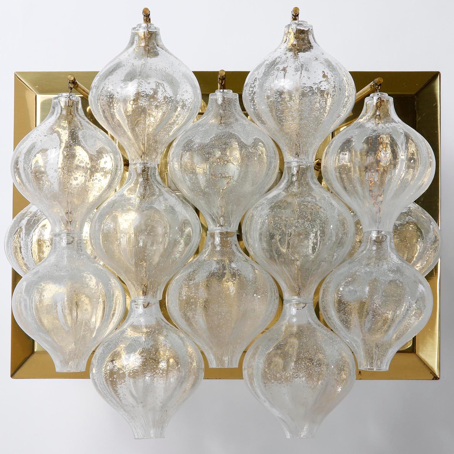 A pair of large 'Tulipan' brass and glass wall light fixtures by J.T. Kalmar, Austria, Vienna, manufactured in midcentury, circa 1970 (late 1960s or early 1970s).
The name Tulipan derives from the tulip shaped hand-blown clear Murano glass pieces.