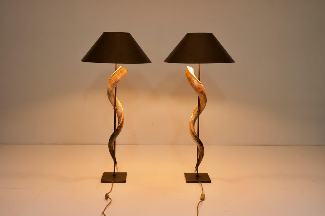 Pair of large Kudo horn table or floor lamps mounted on a brass base. Original shades.

Very good condition.