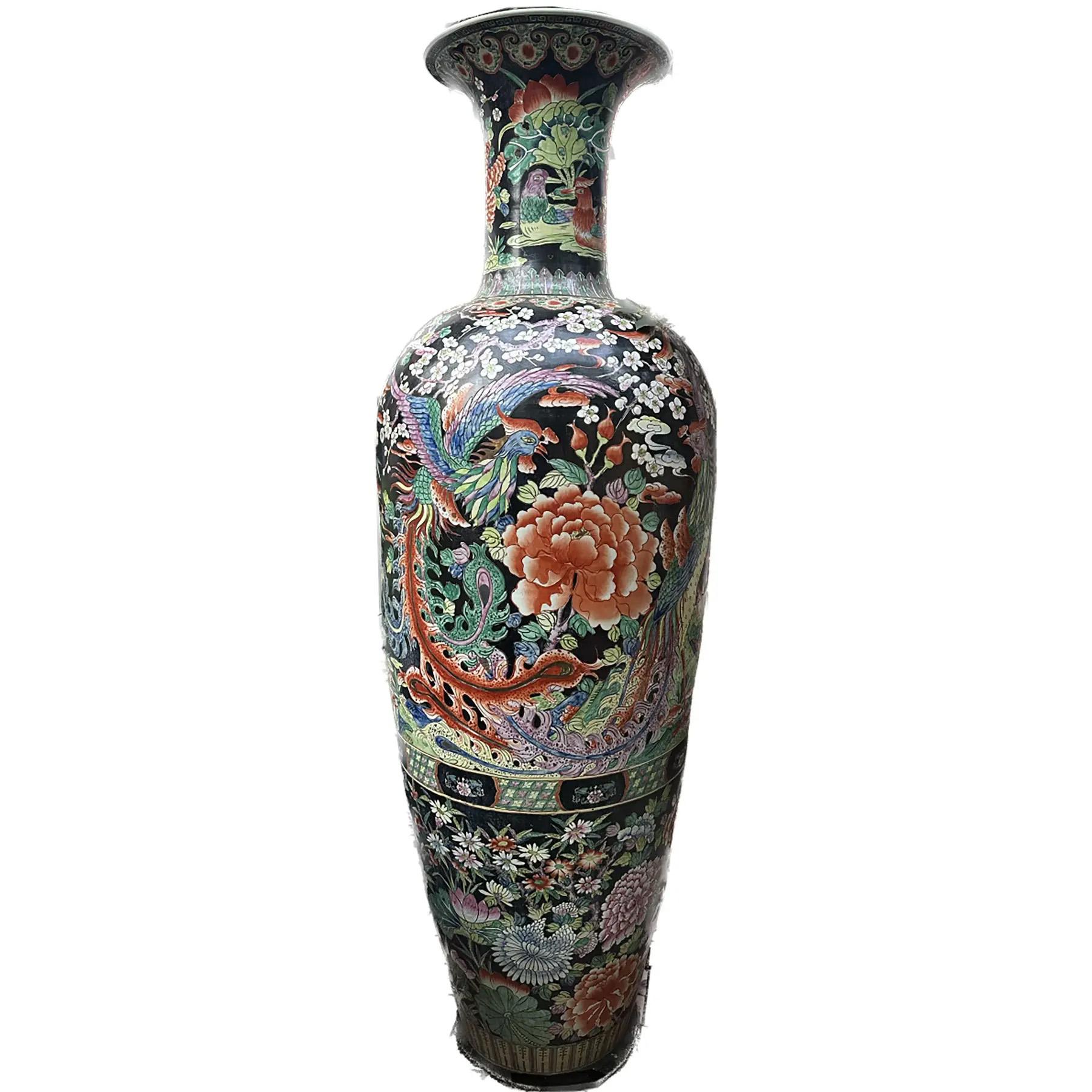 An exquisite pair of monumental hand painted blackground Chinese porcelain Urns. lead based glaze.

Bottle shaped body with an open neck is made of the finest porcelain. A collection of spring flora including hydrangeas, white cherry blossoms, and