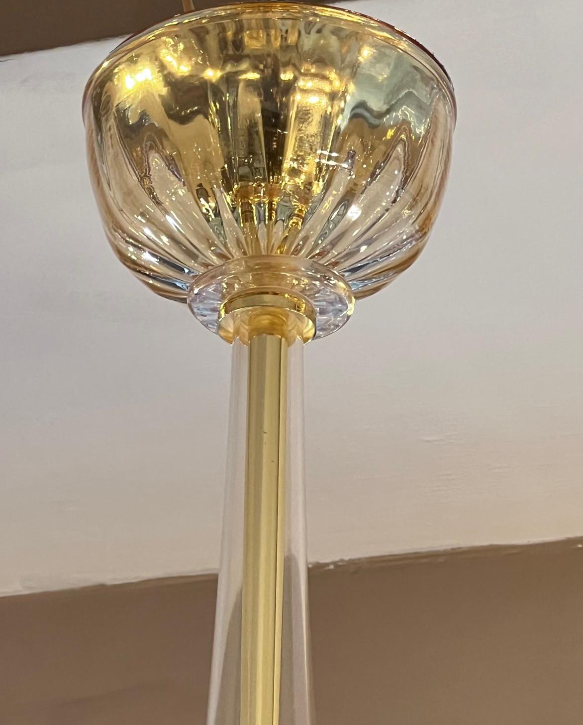 A circa 1960's Italian light amber and gold Murano chandeliers with 8 lights. 

Measurements:
Min. drop: 40