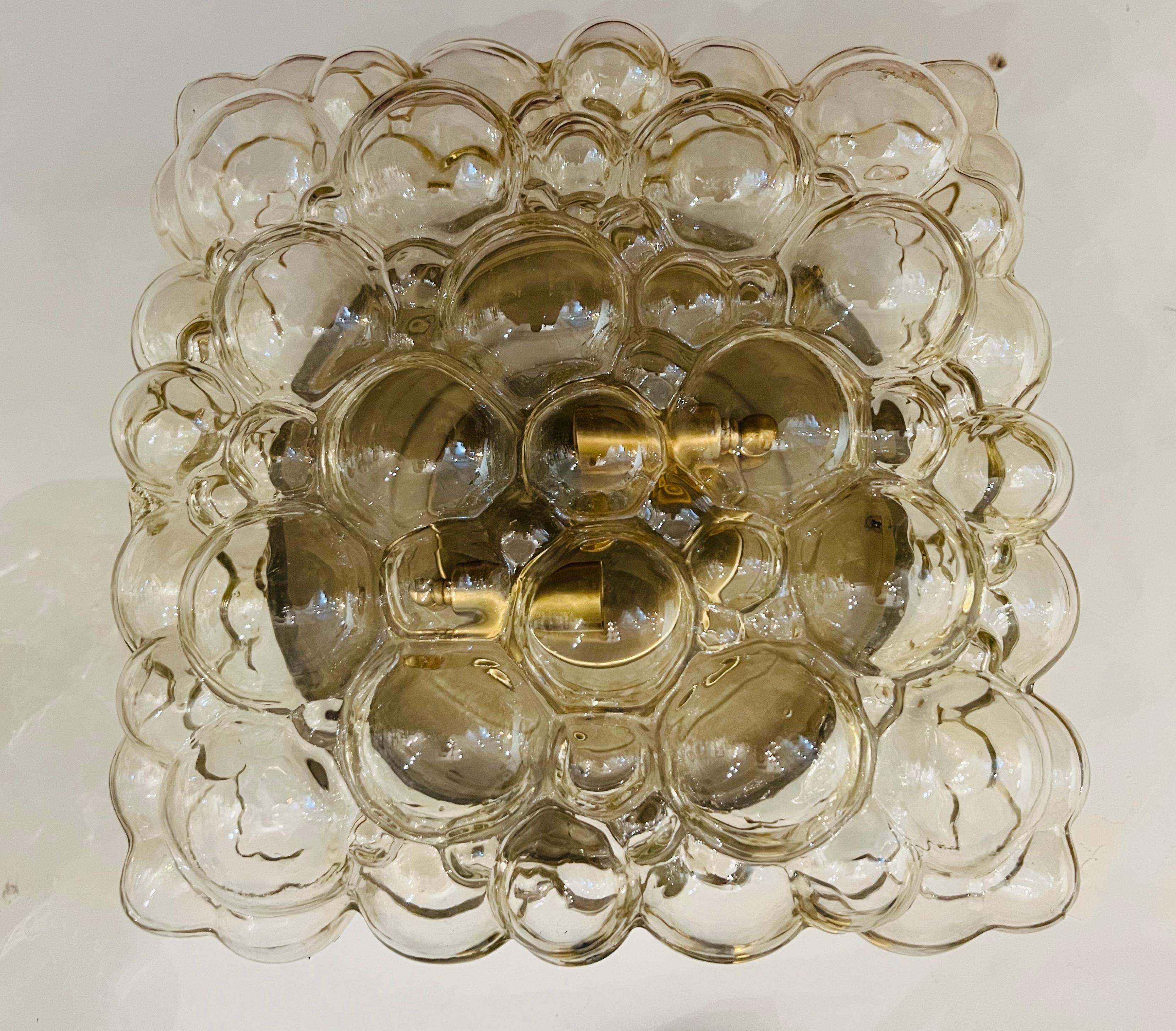 Pair of large flush ceiling or wall lamps composed of light straw colored bubble glass with gold/brass hardware. Newly rewired. Made in 1960 by Limburg.