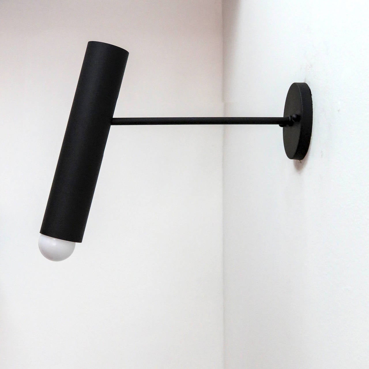 Stunning pair of French wall lights by Lita in flat black enamel, shade swivels up and down and additionally can slide along the arm.