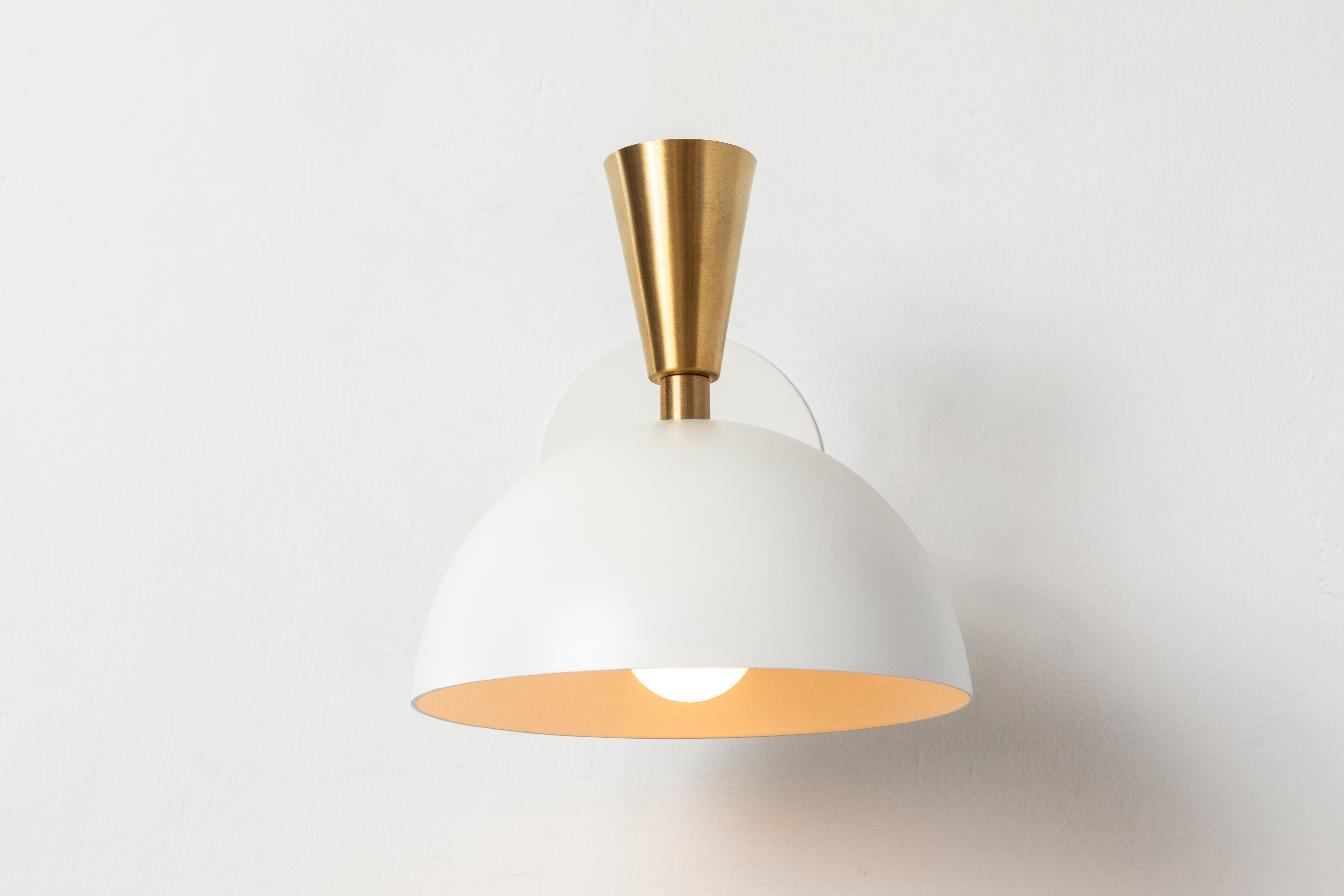 Pair of large 'Lola II' sconces in white metal and brass. 

Hand-fabricated by Los Angeles based designer and lighting professional Alvaro Benitez, these highly refined sconces are reminiscent of the iconic midcentury Italian designs of Arteluce and