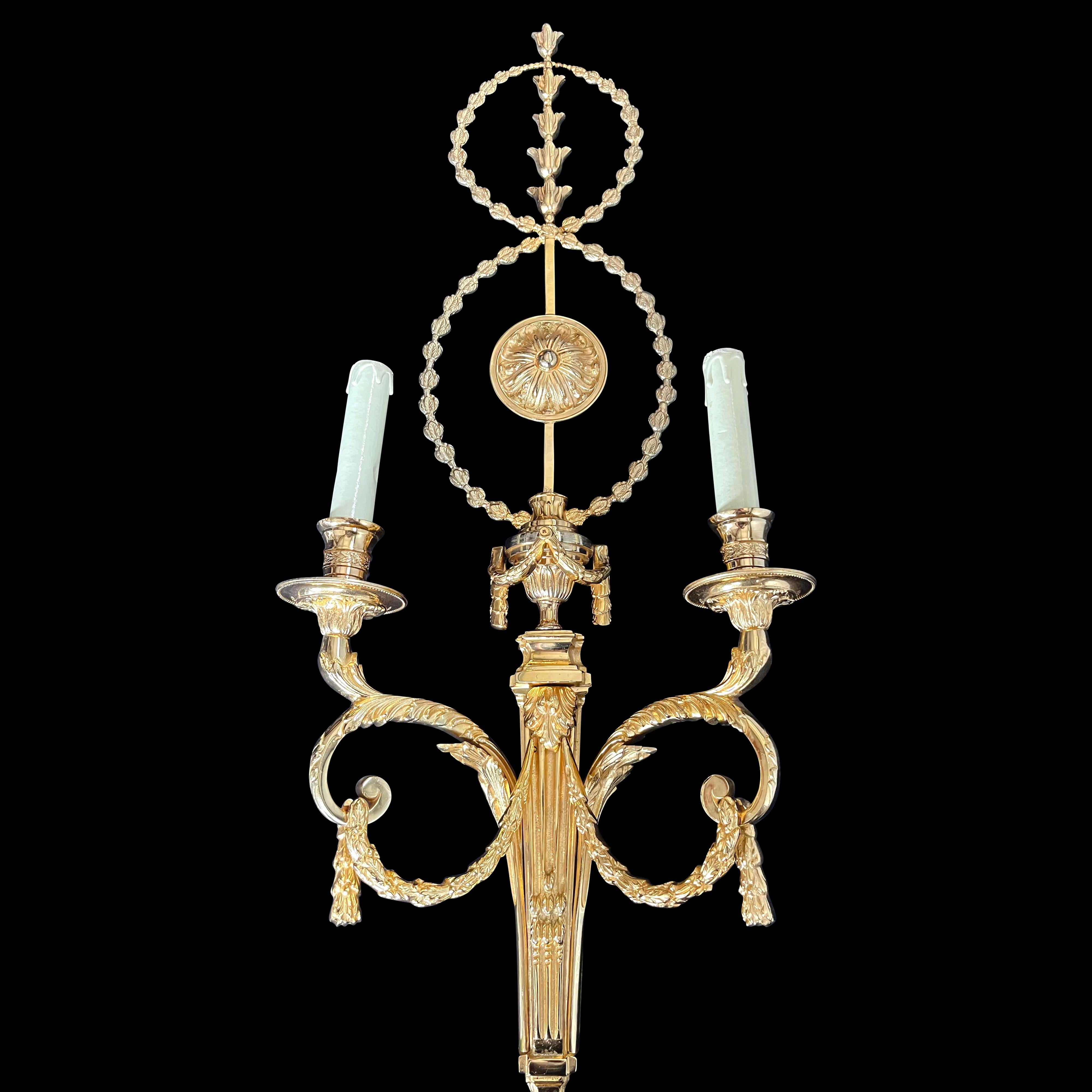 These large Louis XV style wall lights are 24-carat gold plated, have two lights & fret cut leaf detailing, originally removed from Prince Jafrei's, a member of the Sultan of Brunei's family house in Mayfair, London 
