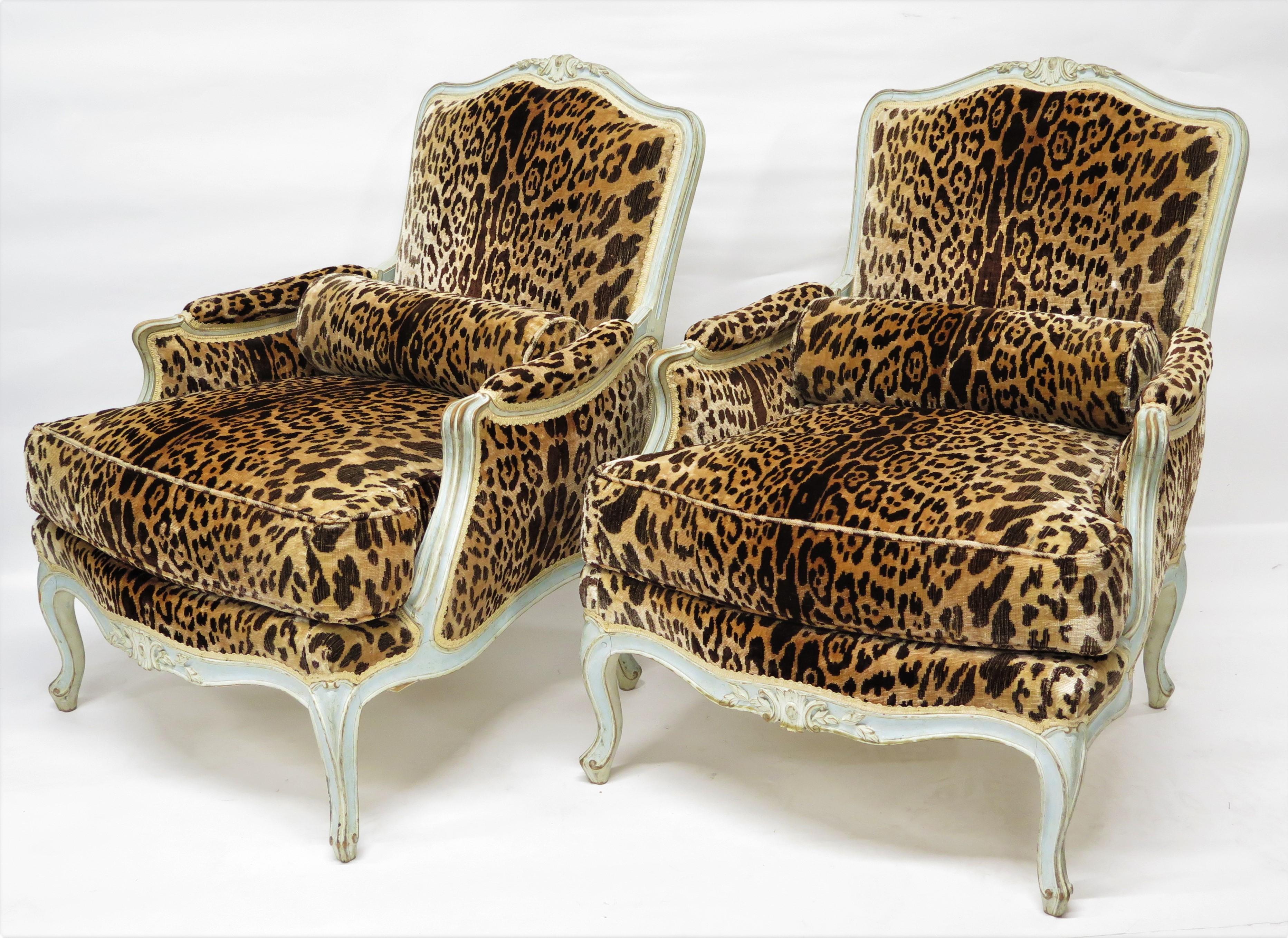 pair of Louis XV-Style bergères carved and painted frames, generously proportioned, commodious, beautifully upholstered in vintage leopard silk velvet, loose seat cushion, bolster-style back pillow, France, late 19th / early 20th century