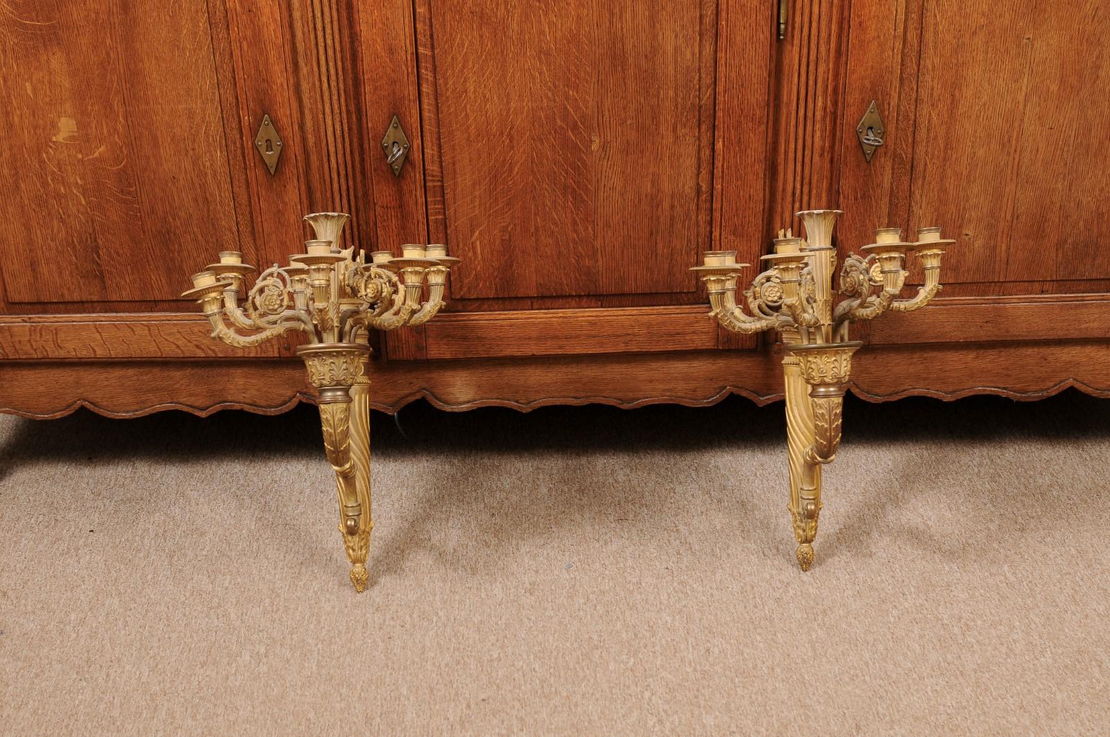 Pair of 19th century French Louis XVI style gilt bronze sconces with seven (7) candle arms. Not electrifed. Can be wired upon request.