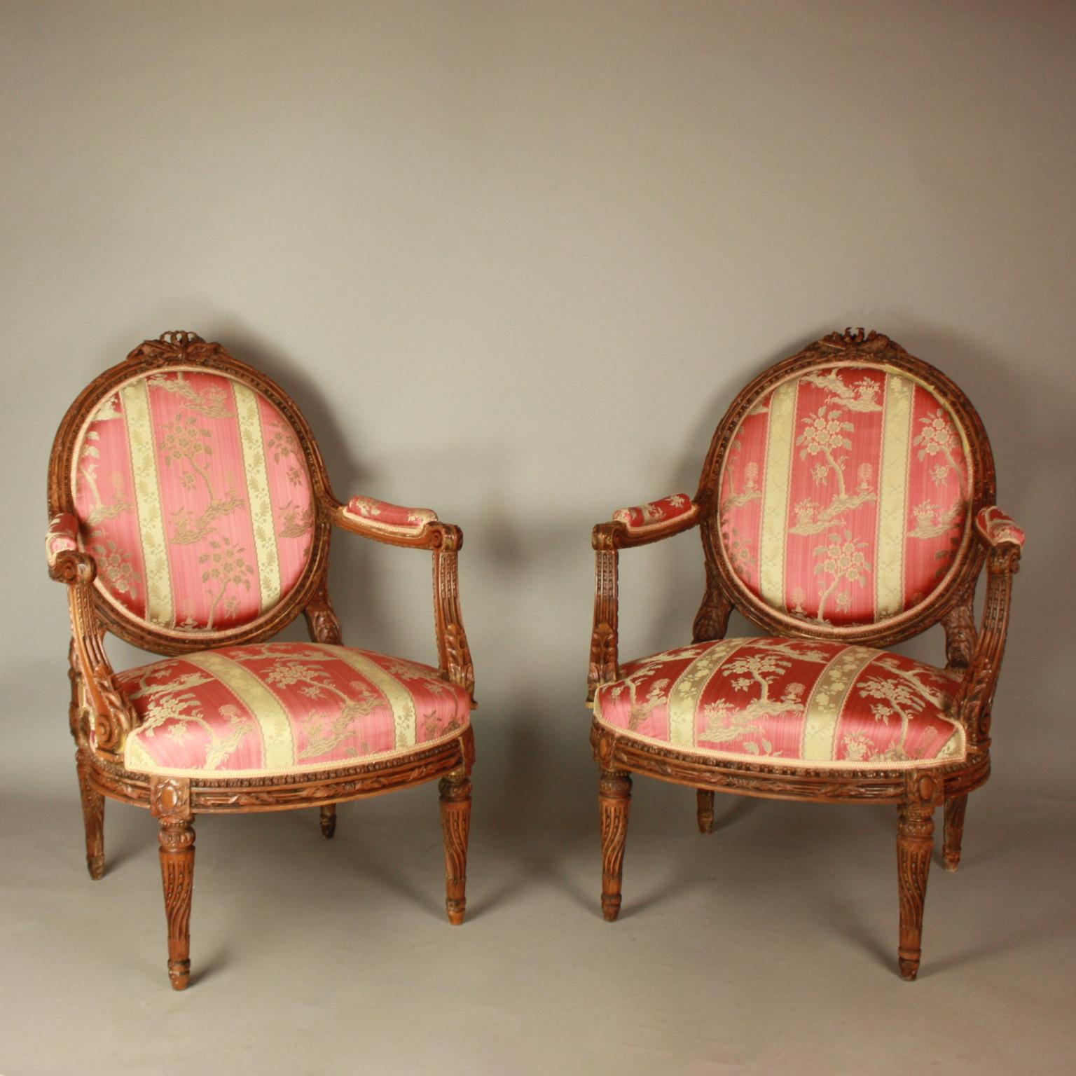 Pair of Large French 19th Century Louis XVI Style Walnut Fauteuils or Armchairs after a model by Jean-René Nadal (1733-1783, Maîtrise 1756): 

A pair of Louis XVI style walnut fauteuils of generous proportions. Each with a medallion back, padded