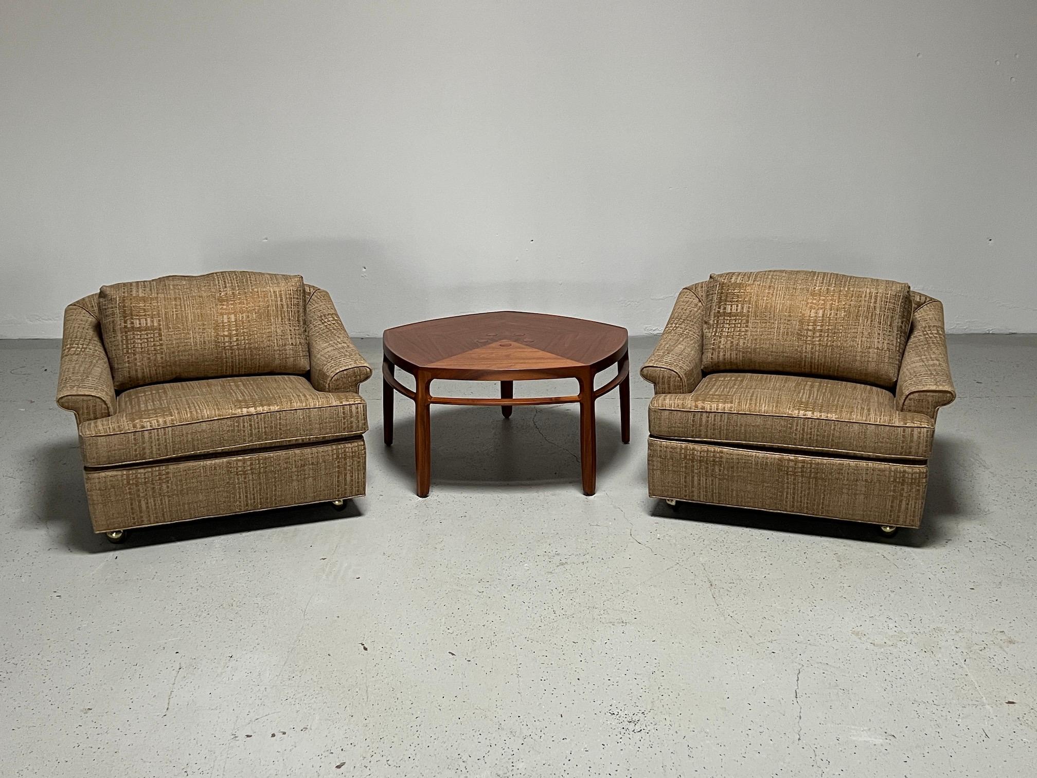 An oversized pair of Edward Wormley for Dunbar lounge chairs with full down back cushions, sitting on four casters. Matching ottoman on casters as well. Fully restored and upholstered in Donghia fabric.