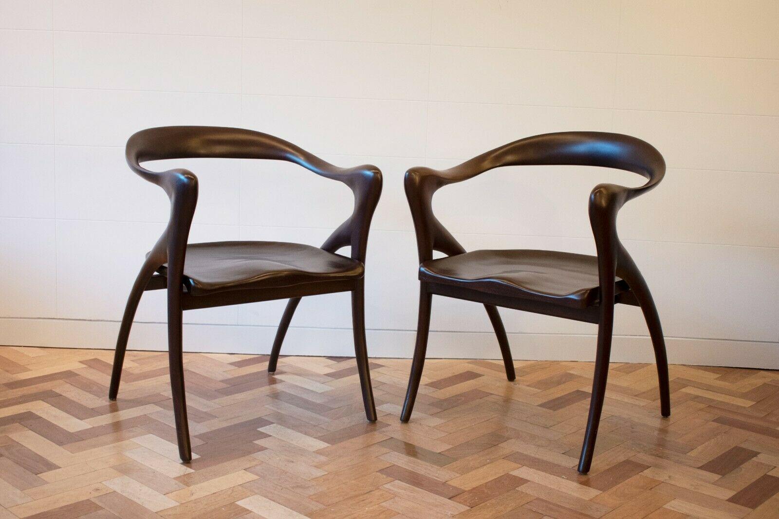 Pair of large mahogany armchairs Model Ode A La Femme by Olivier Schrijver

These Belgian armchairs feature sculptural, sinuous shaped mahogany armrests and back, with sculpted curved seats.

These chairs are surprisingly comfortable as they