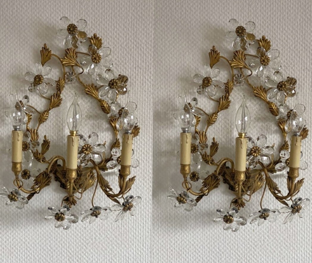  Amazing, rare pair of large Maison Bagès gilded wrought iron three-arm wall sconces, France, 1930s. Wonderful handcrafted  gilded wrought iron leaf environment, enriched with clear faceted crystal flowers and a crystal obelisk in the center,